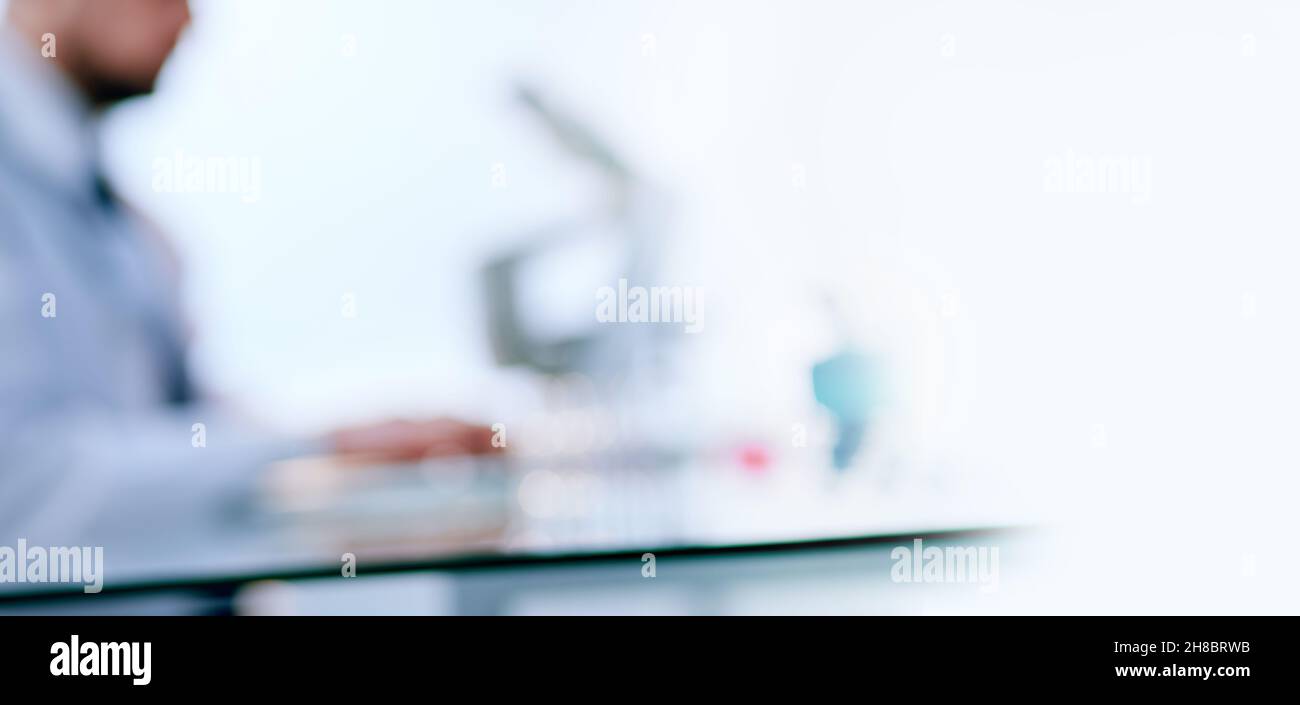 scientist using a laptop while working in the lab. Stock Photo