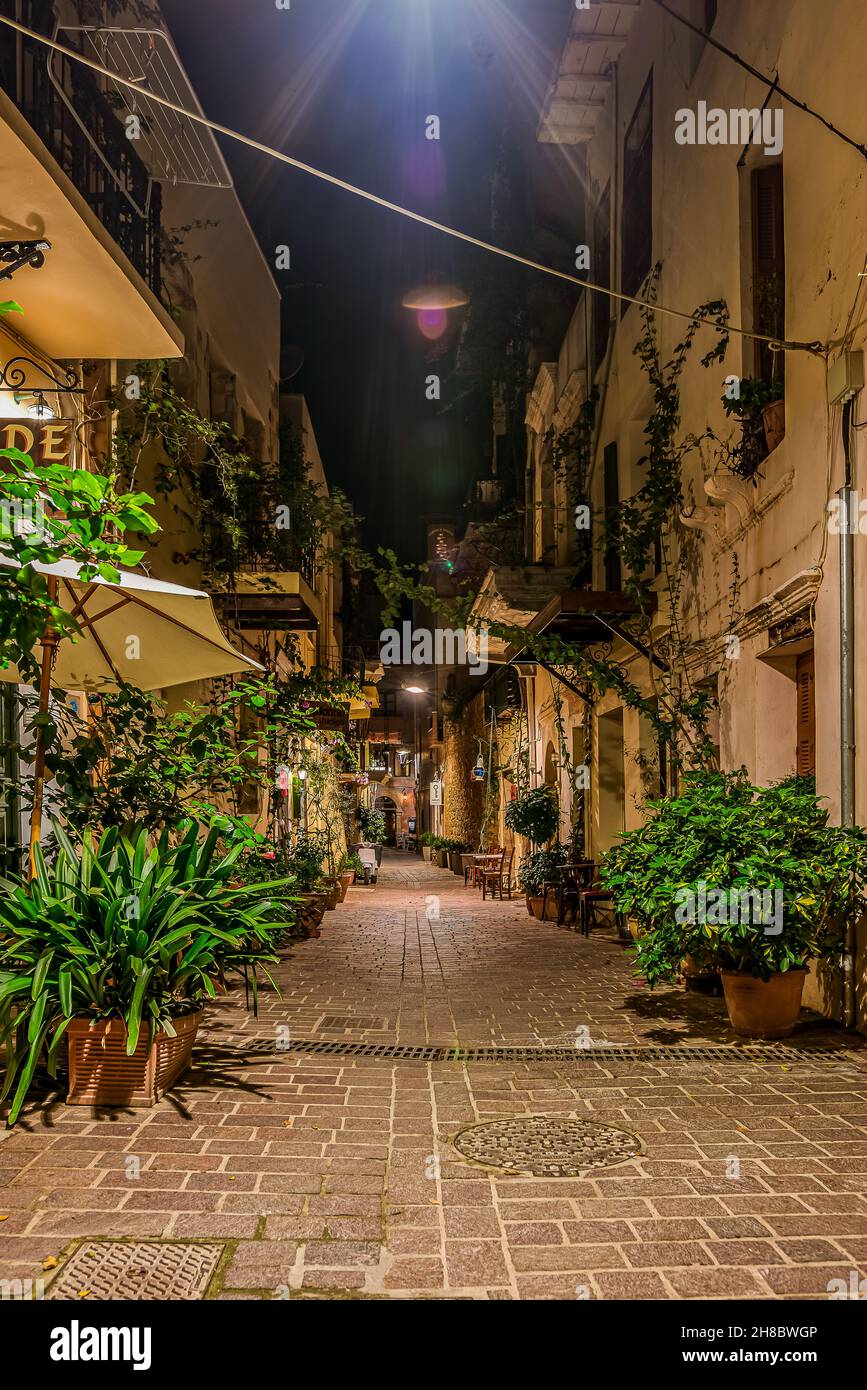 The illuminated alley Antoni Gampa with green plants and balconies in the old town of Chania, Crete, Greece, October 13, 2021 Stock Photo