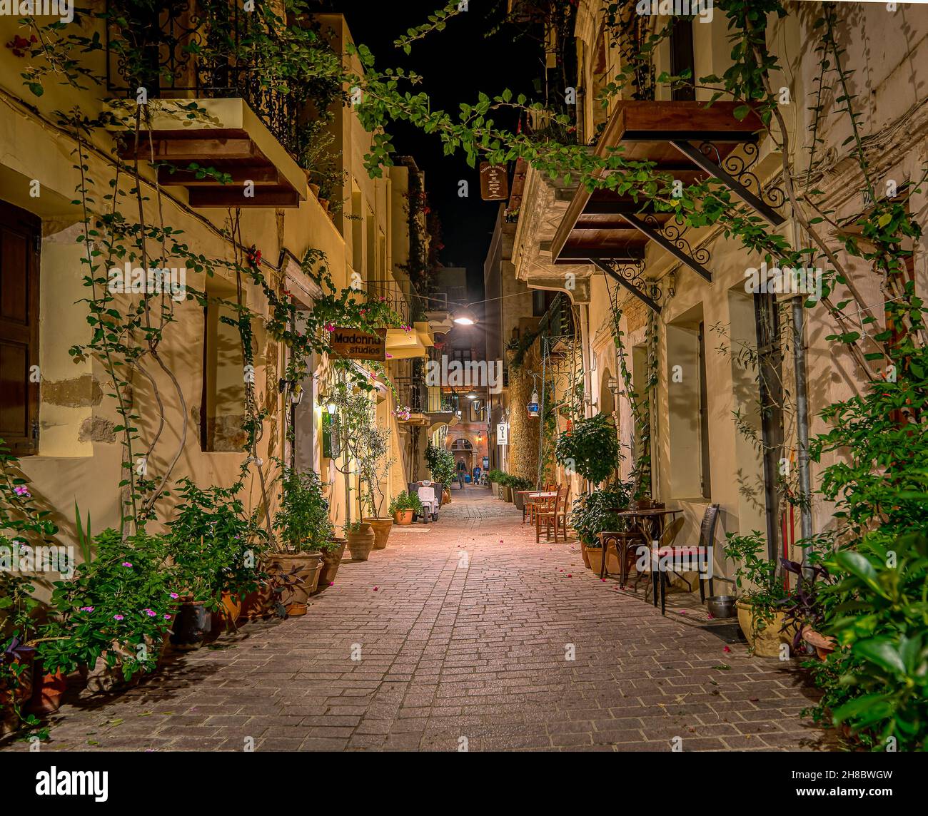 The illuminated narrow alley Antoniou Gampa with flowers and balconies in the old town of Chania, Crete, Greece, October 13, 2021 Stock Photo