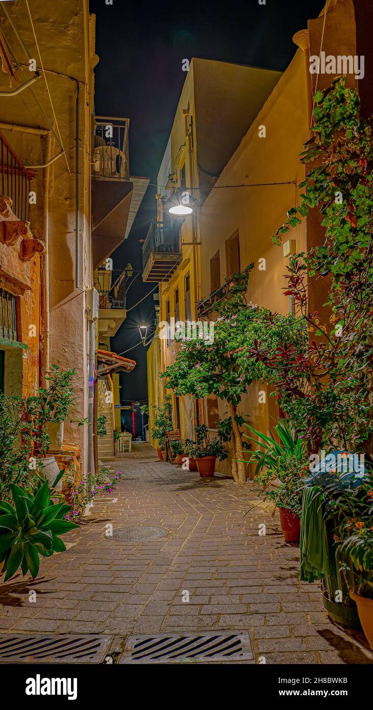 Romantic alley at night illuminated by a street lamp in the old town of Chania, Crete, Greece, October 13, 2021 Stock Photo