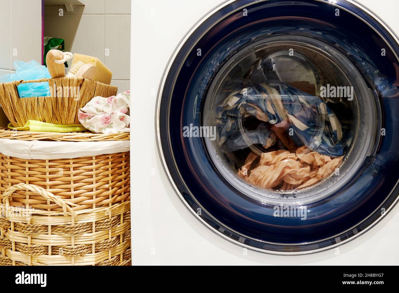 Washing machine in the laundry and basket for dirty clothes. Home