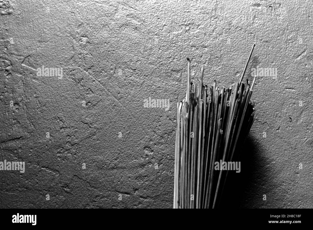 Coconut broomstick hanging on the wall. Stock Photo