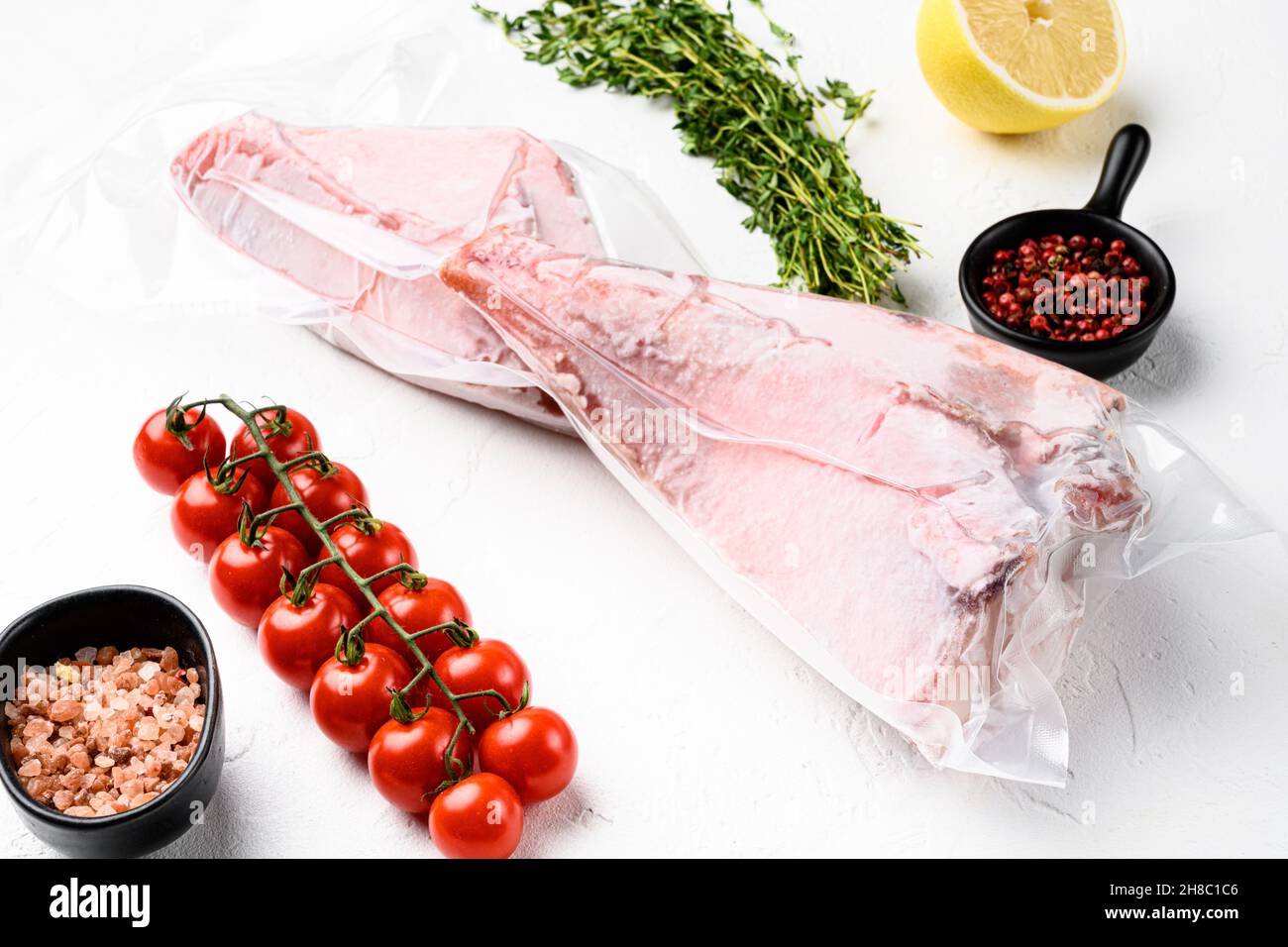 Red perch frozen pack fish meat set, with herbs, on white stone table ...