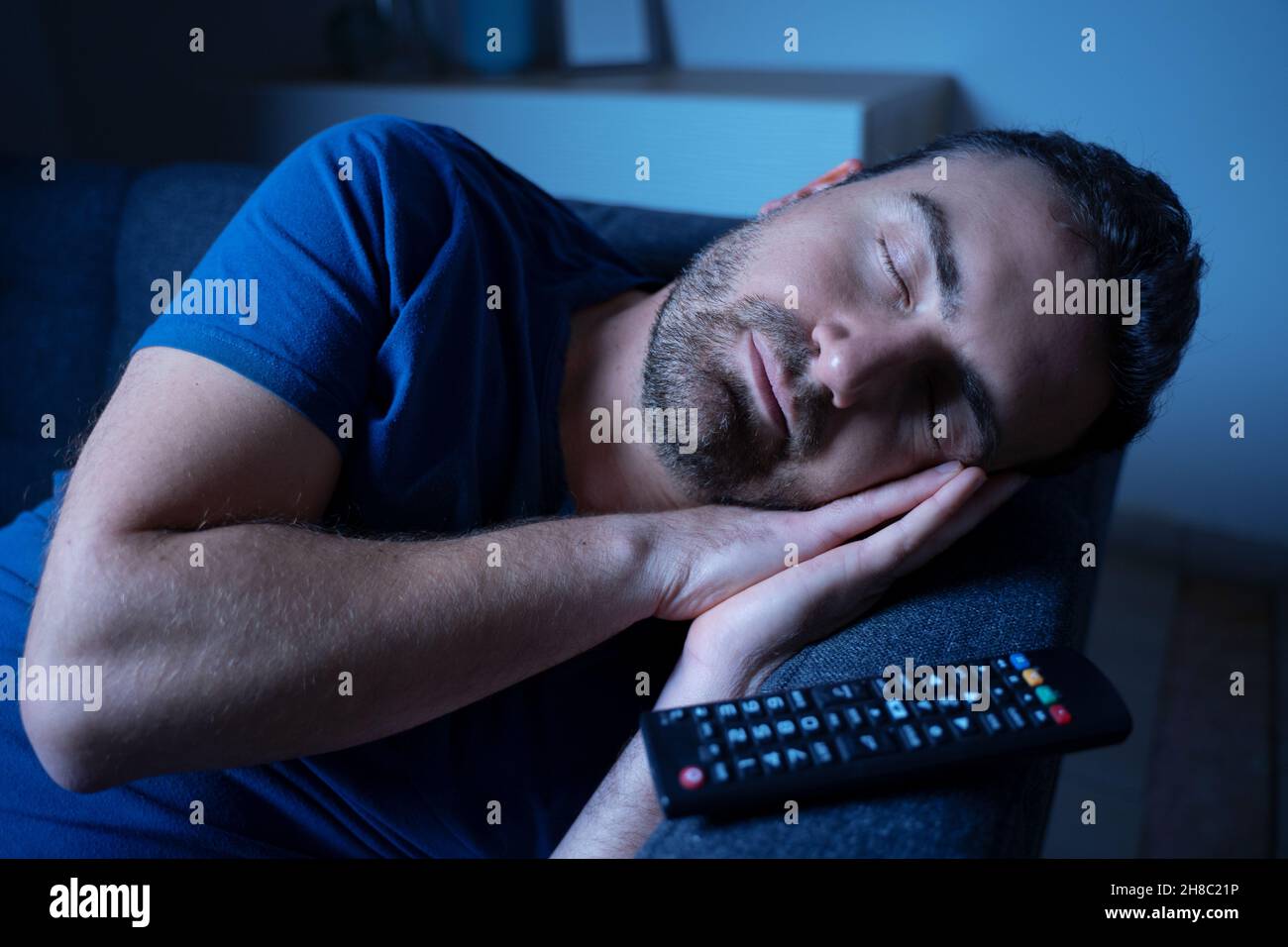 One man sleeping and snoring watching television Stock Photo Alamy