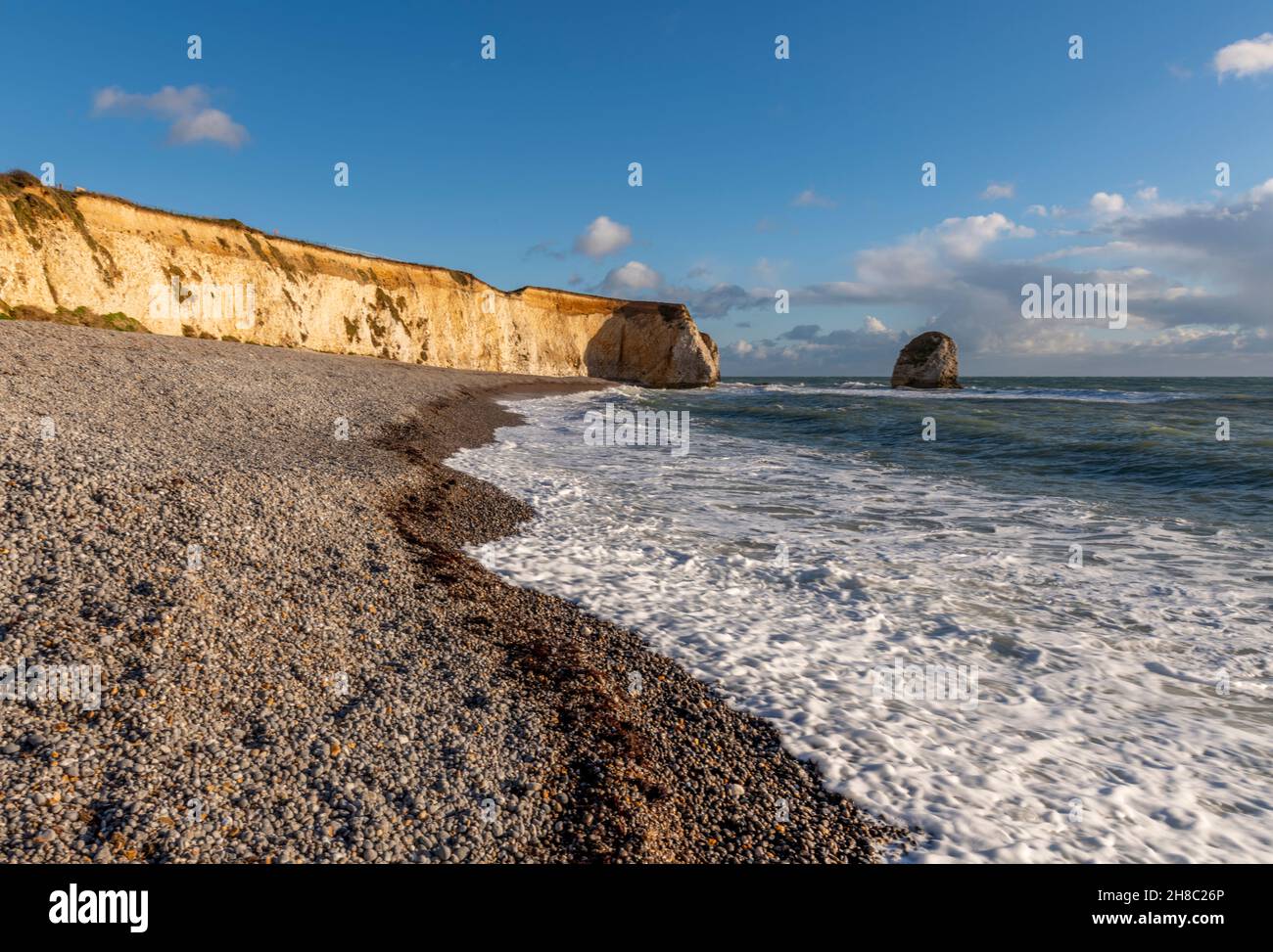 freshwater bay on the isle of wight coastline, waves breaking onto the shore on the shoreline of the isle of wight at freshwater bay, island scenery. Stock Photo