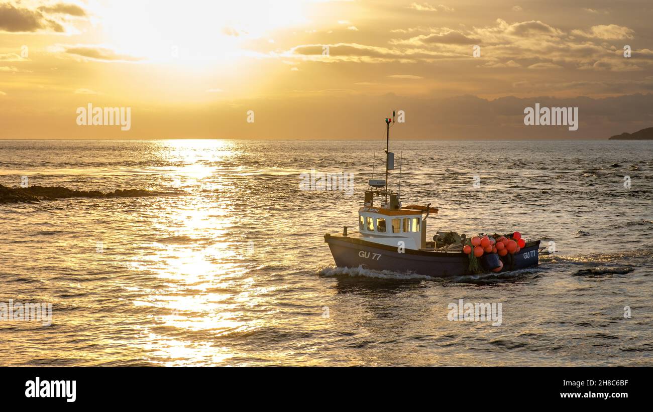 fishing boat at sunset Stock Photo
