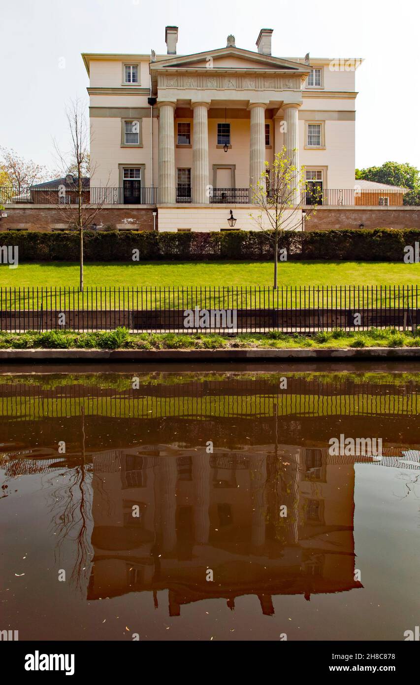 View of an imposing Mansion and its reflection in the still waters of the Regents Canal, London Stock Photo