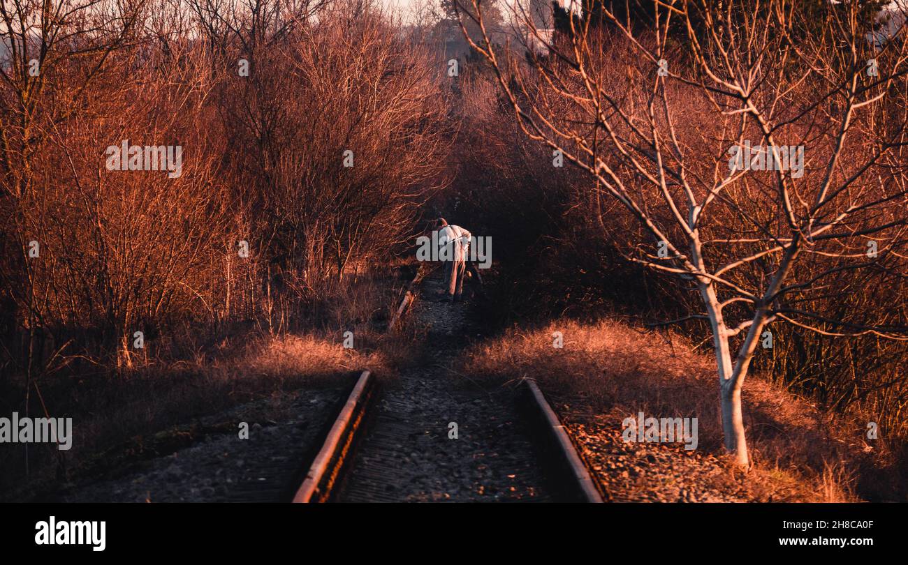 Person working on the railroad tracks. Stock Photo