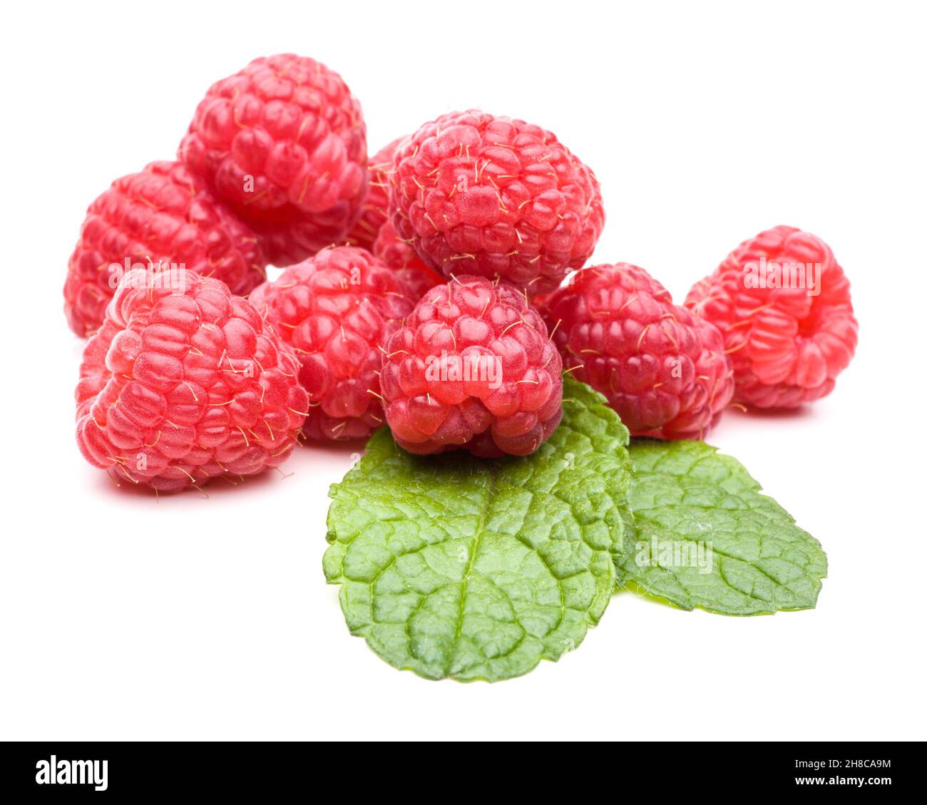 Red raspberries are two green mint leaves isolated on white background Stock Photo