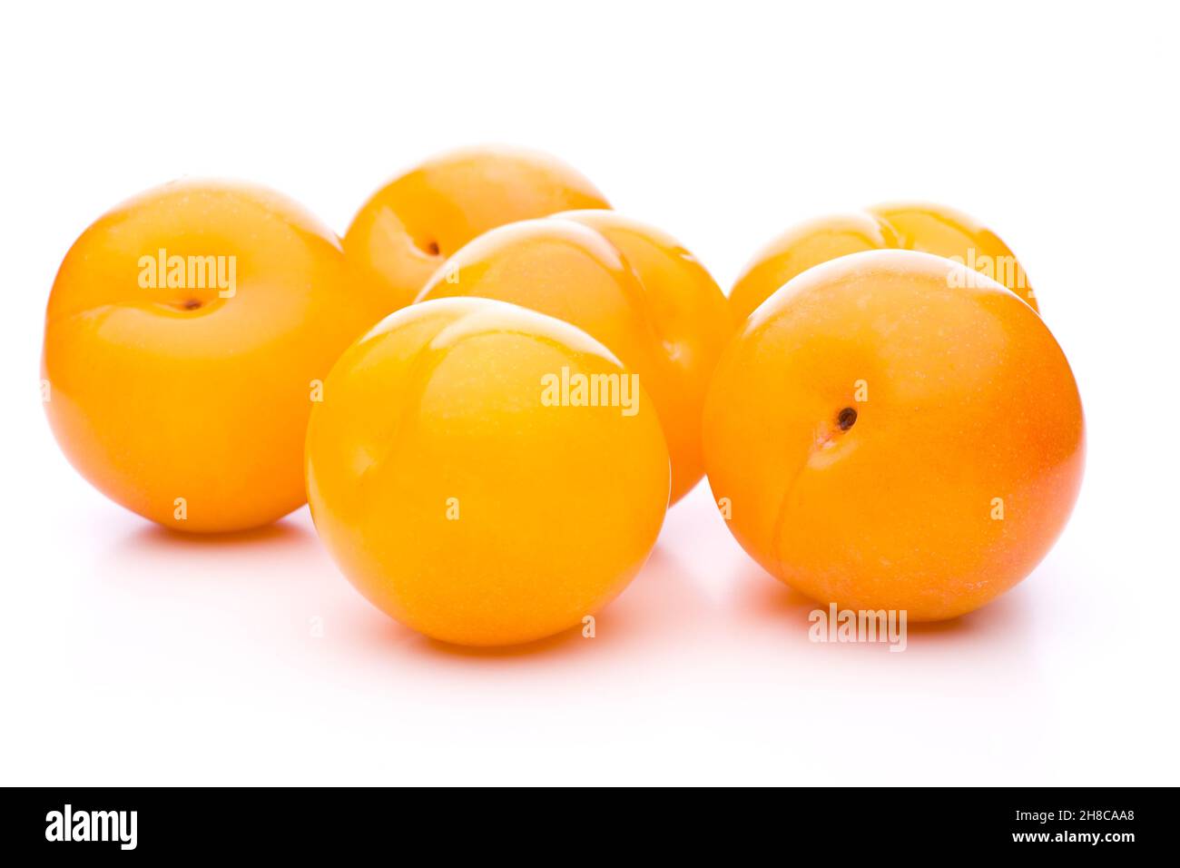 Six orange plums loosely arranged on white Stock Photo Alamy