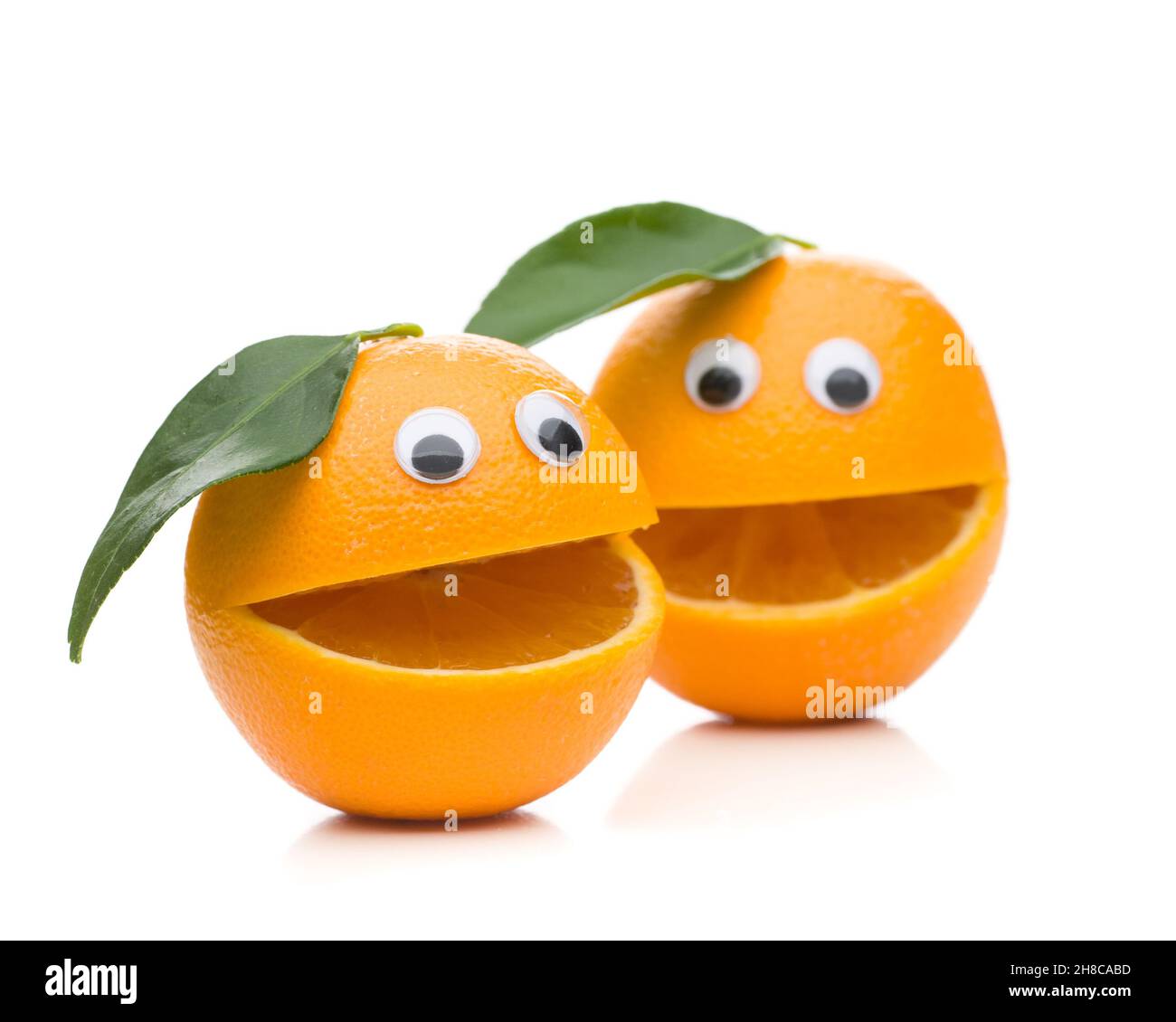 Two speaking oranges with leaf isolated on white background Stock Photo