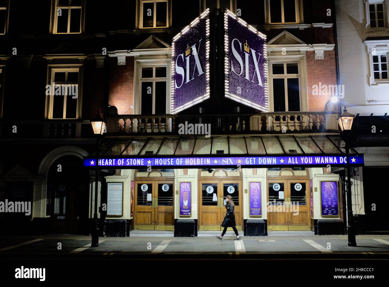A lady walking past the Six The Musical  theatre, Shaftesbury Avenue, London during the Coronavirus pandemic lockdown, London Stock Photo