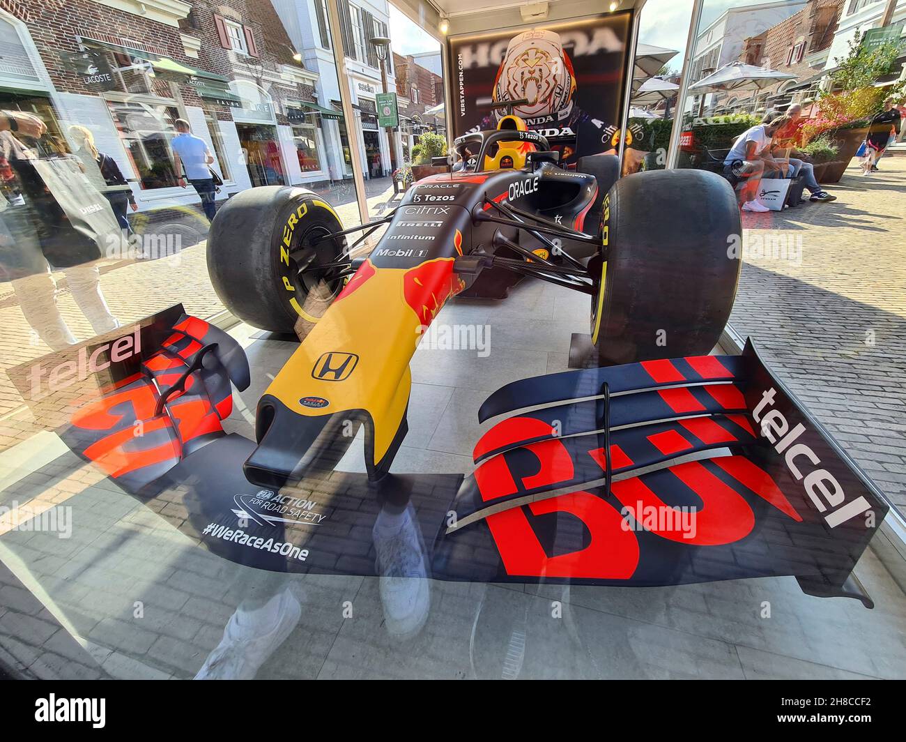 Formula One car displayed in a glass box in the pedestrian zone Stock Photo