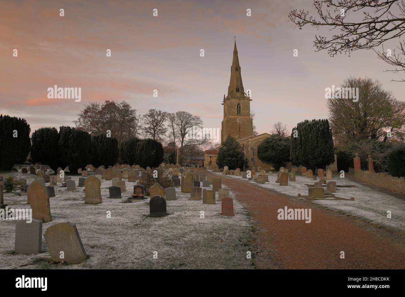 Sharnbrook, Bedfordshire, England, UK - Winter scene of old village church and churchyard at sunrise with frost and snow Stock Photo