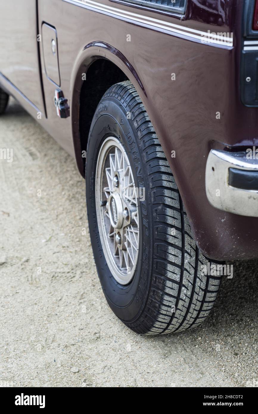 Close up detail of the rear wheel on a dark purple brown Suzuki Fronte