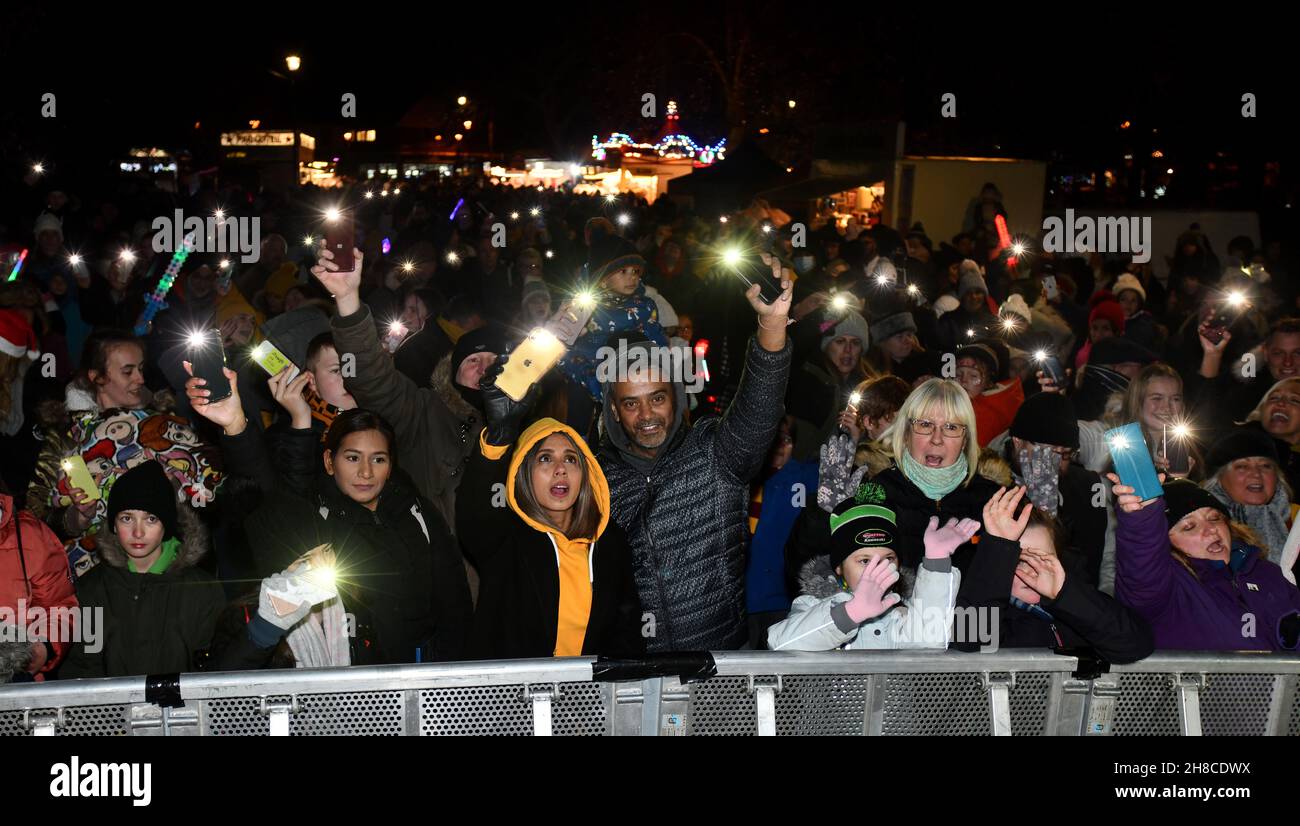 Christmas community spirit residents wave mobile phone lights torches