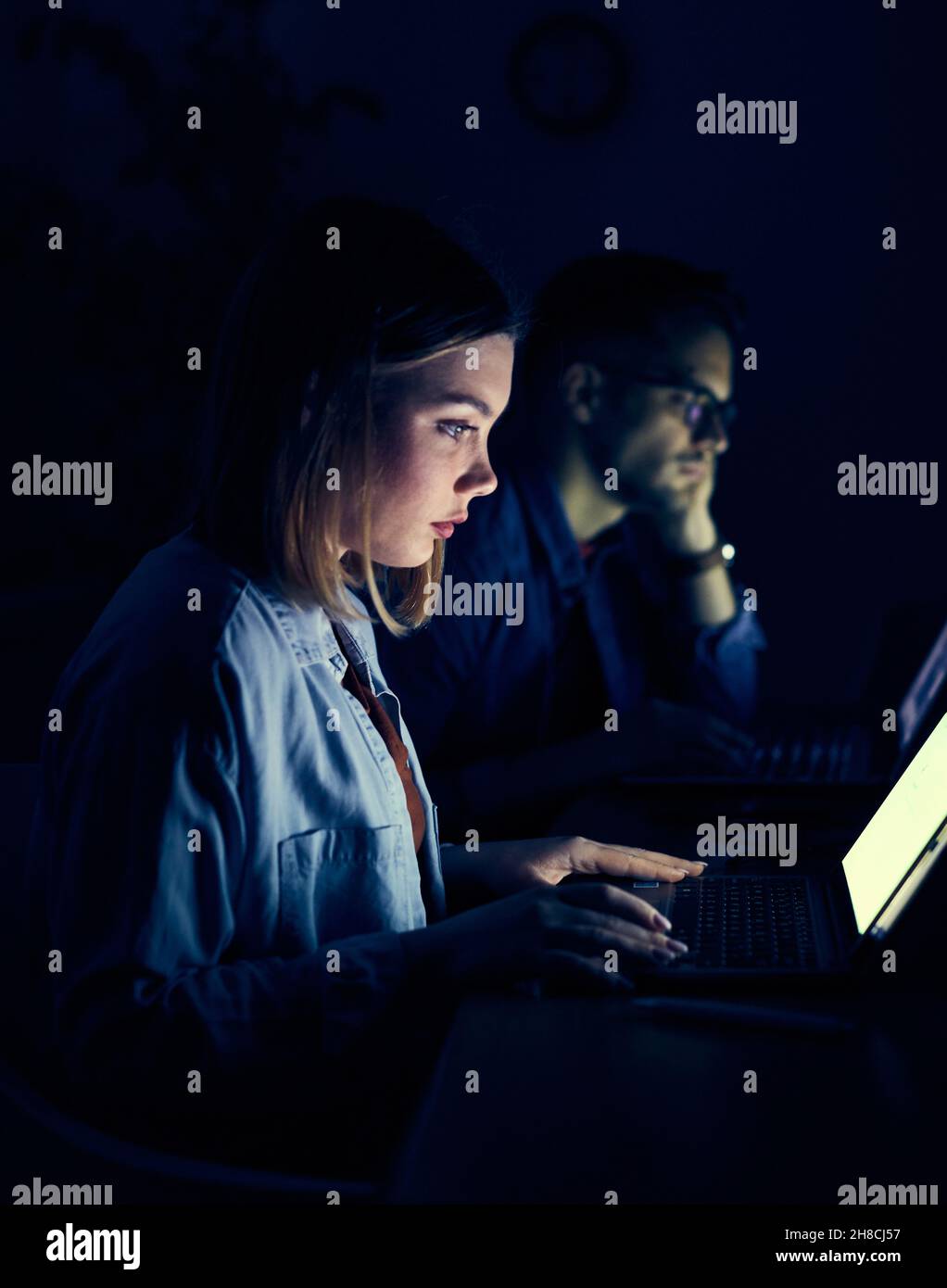 laptop computer, night dark looking office late working ciner crime theft Stock Photo