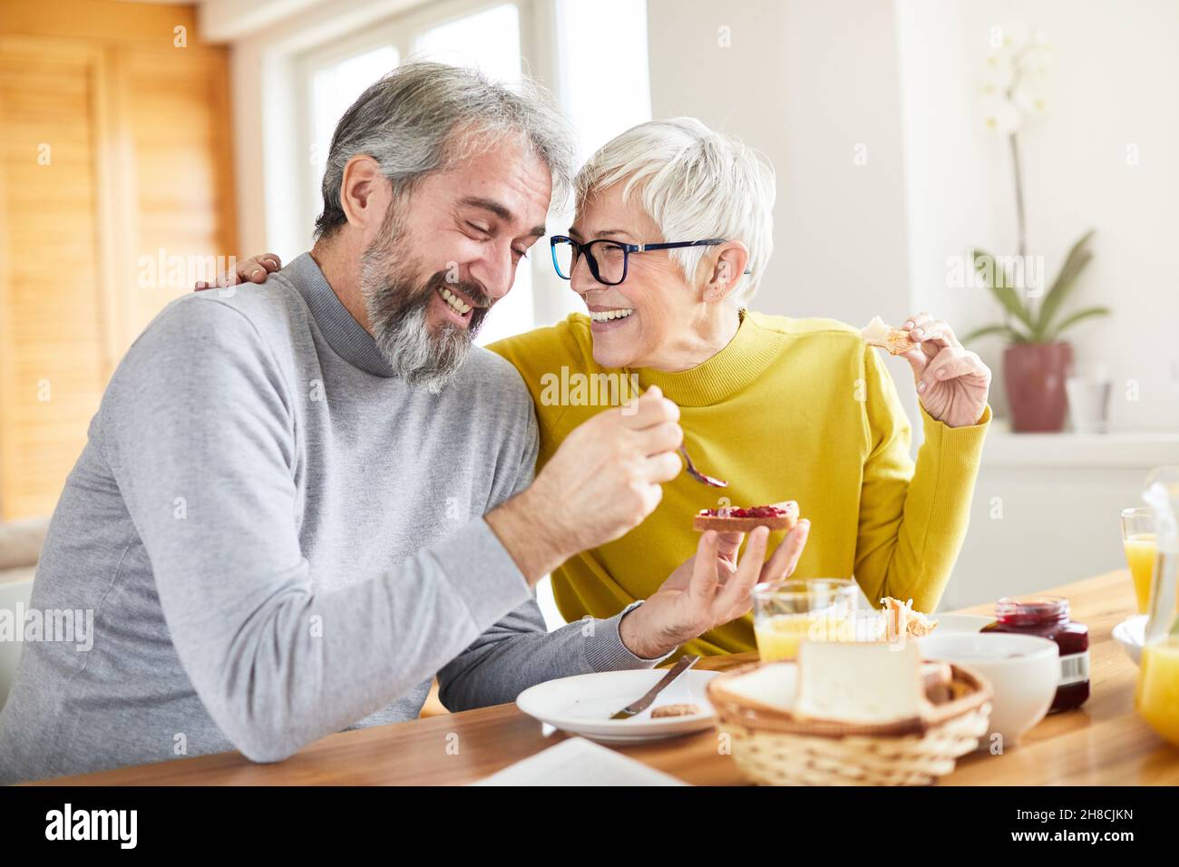 senior couple breakfast home food lifestyle eating table Stock Photo