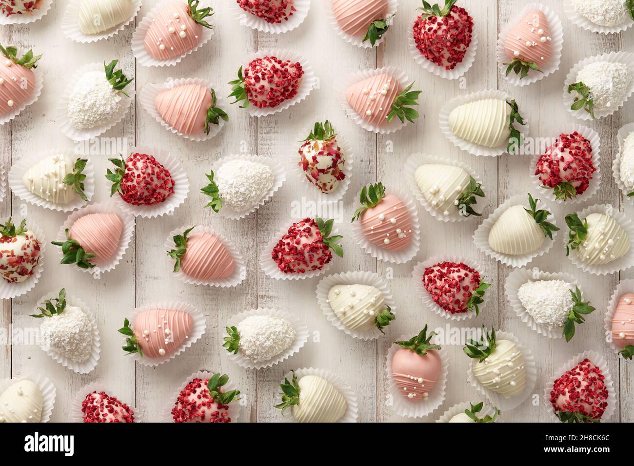 Chocolate dipped strawberries pattern on white planks Stock Photo