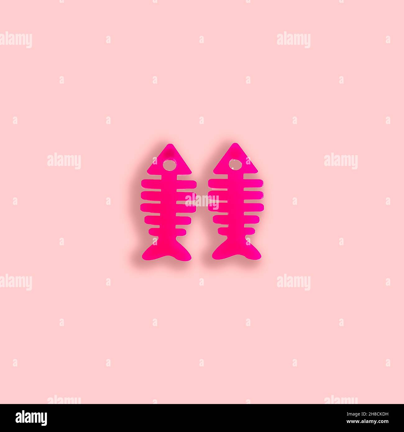 Material methacrylate with a fish shape design on a pastel color background. Stock Photo