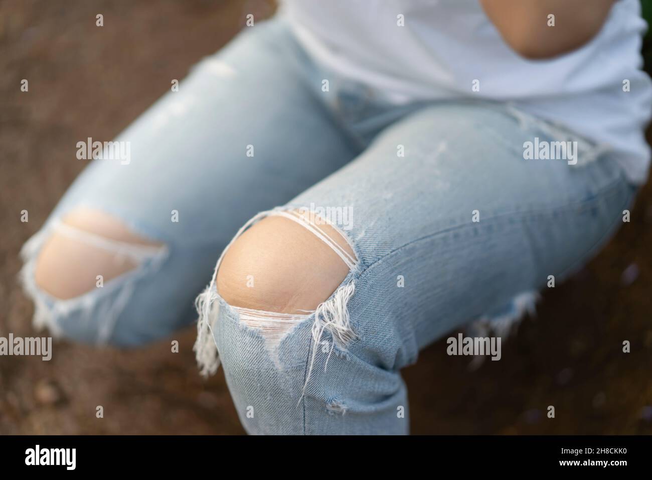 Jeans torn or ripped jeans Asian female leg focus and close up to