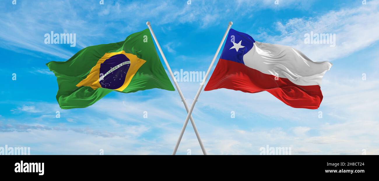 crossed national flags of Brazil and Chile flag waving in the wind at ...