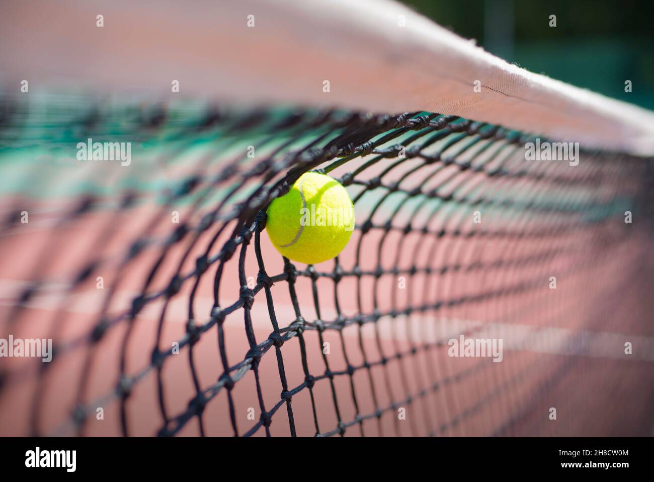 Tennis ball hits in the net during game Stock Photo Alamy