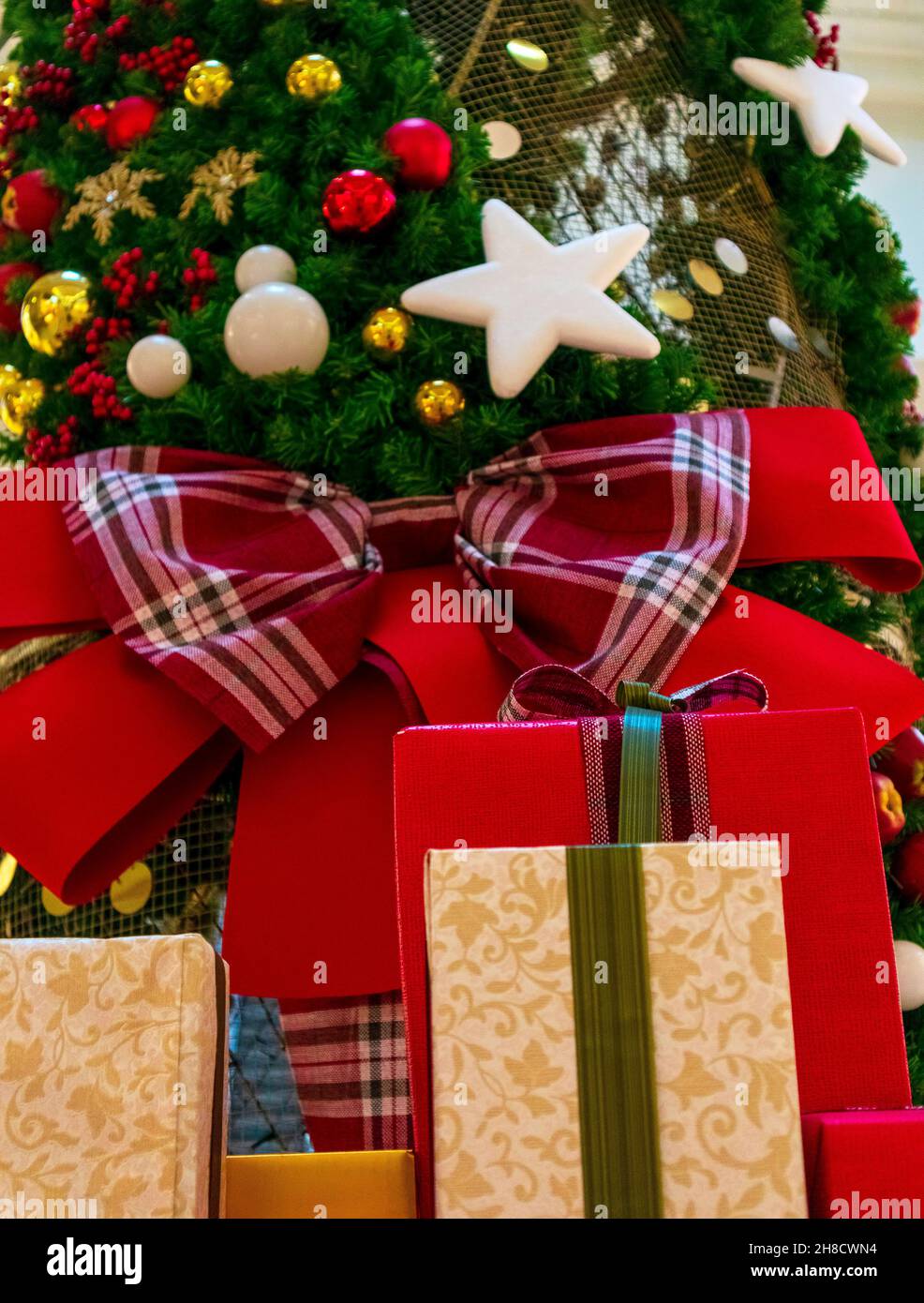 boxes with Christmas or New Year's gifts under the tree Stock Photo