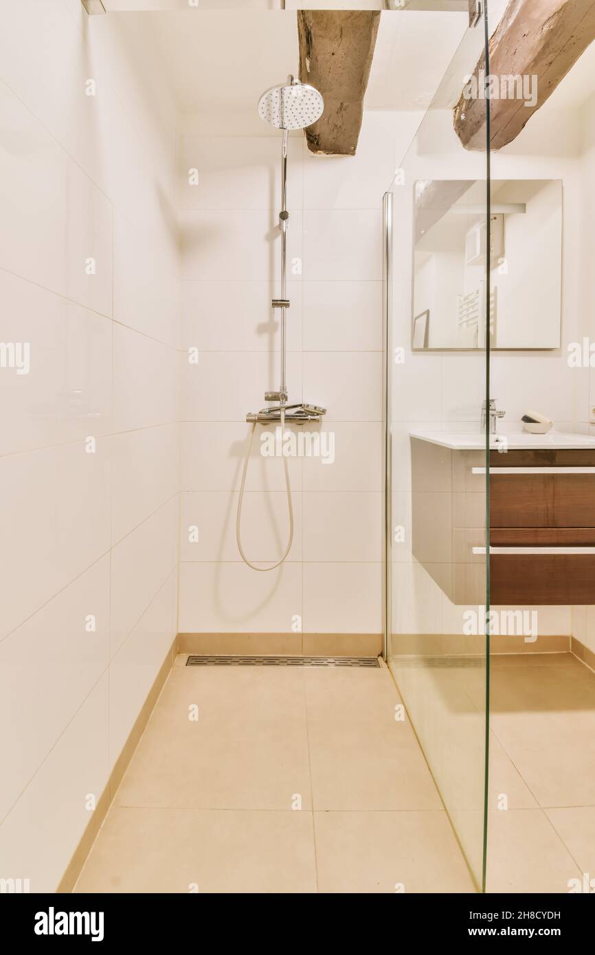 Luxurious shower cubicle with glass partition and modern tap Stock