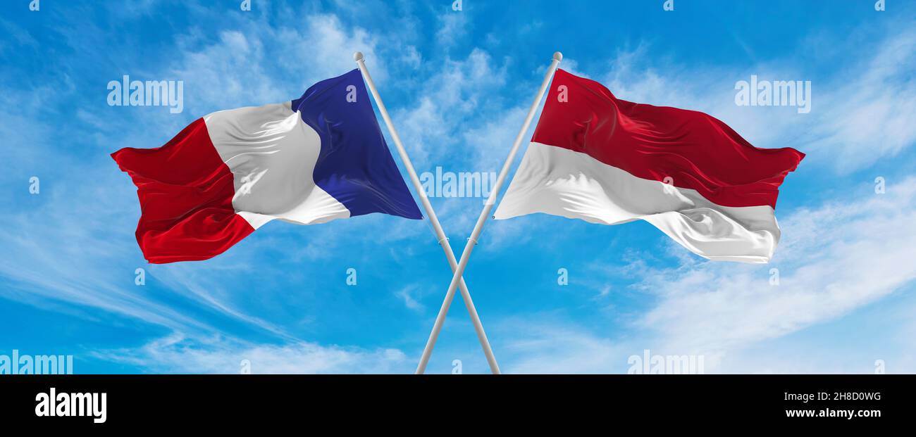 crossed national flags of France and Indonesia flag waving in the wind ...