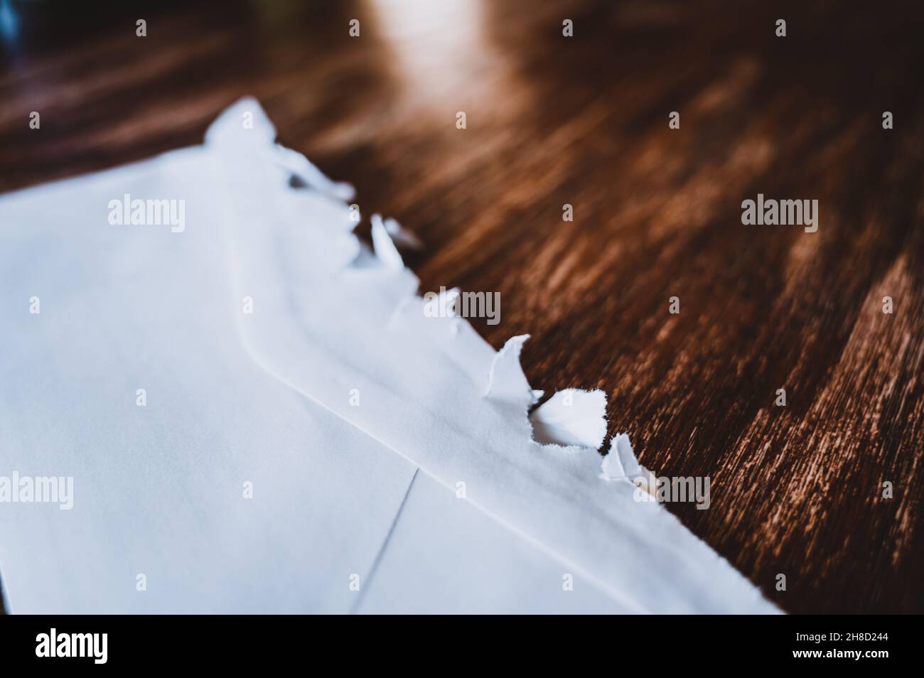 Selective focus on jagged edges of a ripped open mail envelope Stock Photo Alamy