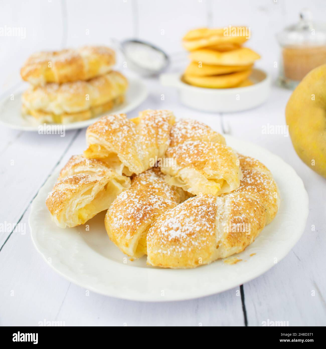 Apple rings in puff pastry, with cinnamon and powdered sugar Stock
