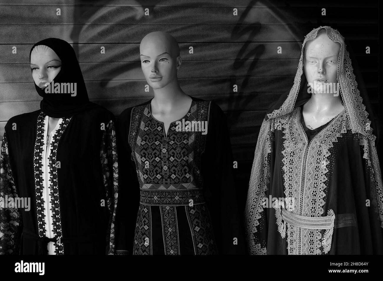 Grayscale shot of mannequins wearing eastern clothes and hijab Stock Photo