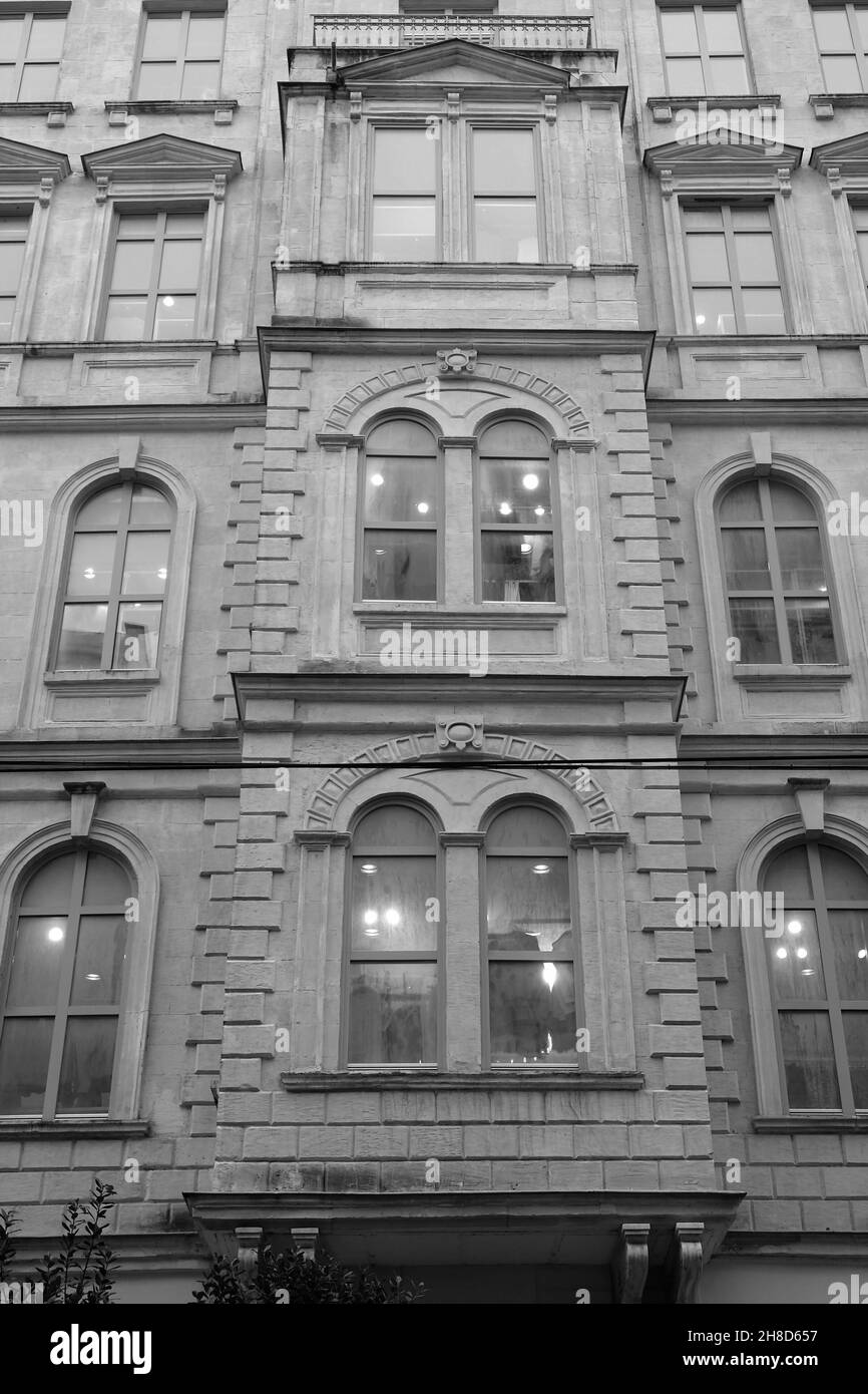Vertical grayscale shot of the exterior of a building Stock Photo - Alamy