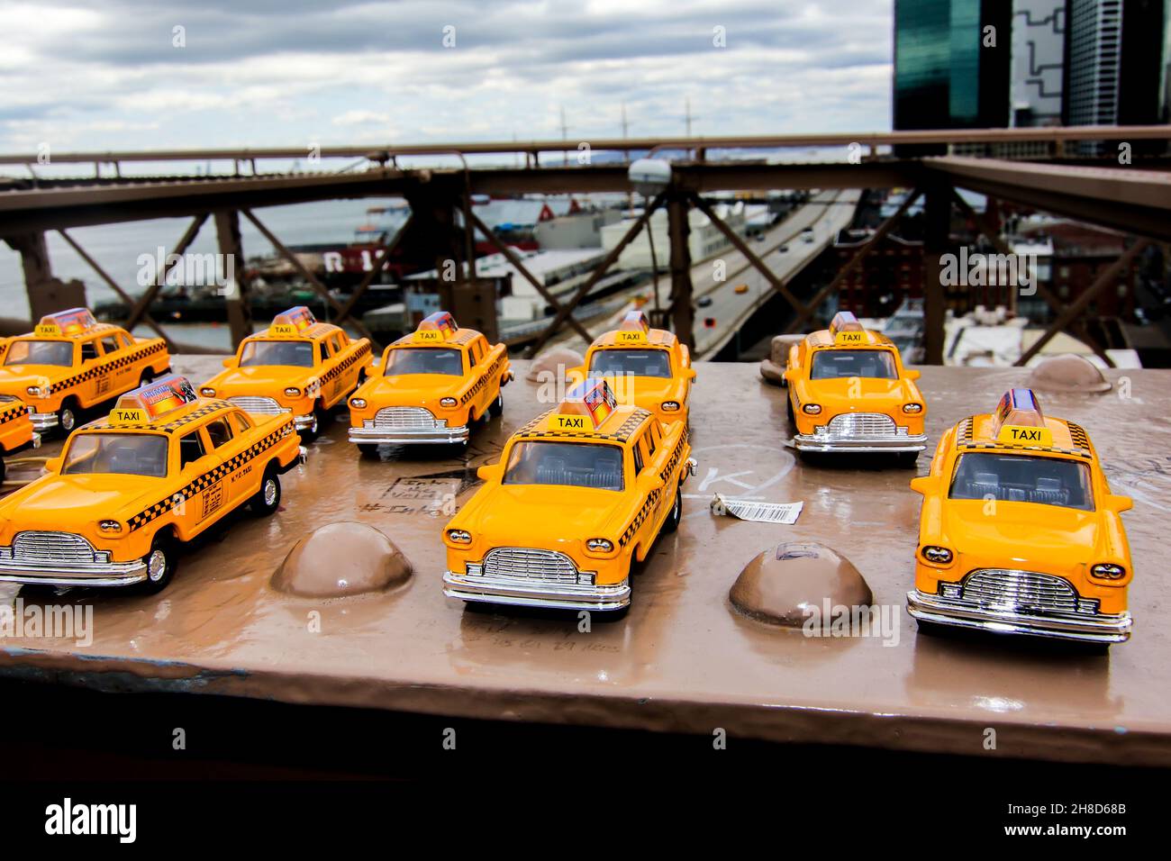 NEW YORK CITY, NY, USA-APRIL 22, 2014: New York city architecture in lower Manhattan with cabs toy cars on Brooklyn bridge in New York, Stock Photo