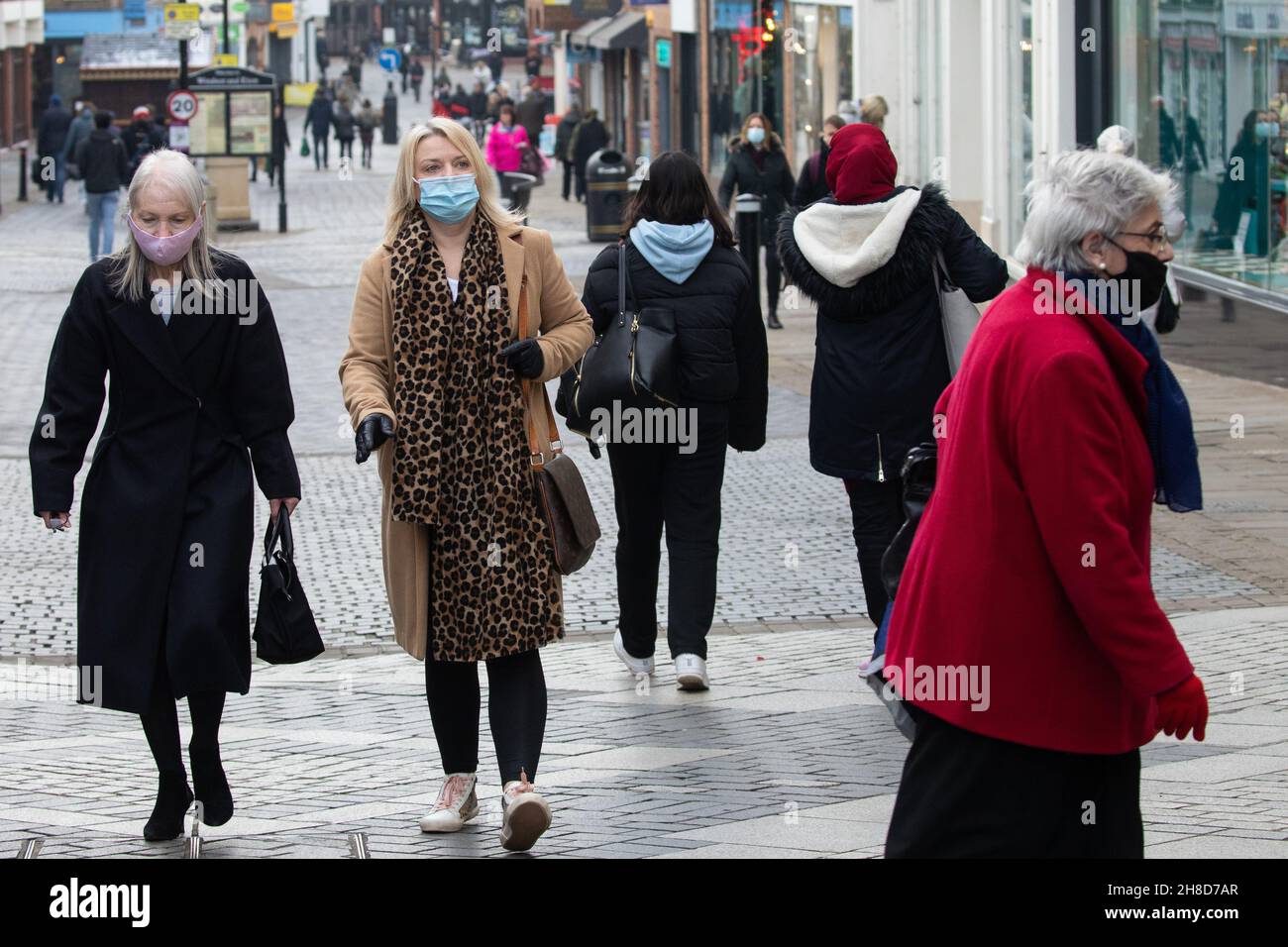 Windsor, UK. 29th November, 2021. Shoppers pass through the town centre wearing face coverings. The Health Secretary Sajid Javid yesterday announced following the emergence in the UK of the Omicron coronavirus variant that the wearing of face masks would become mandatory in shops and on public transport with effect from 4am on 30th November, with fines ranging between £200-£6,400 to be issued to people in England who fail to wear them depending on the number of offences. Credit: Mark Kerrison/Alamy Live News Stock Photo