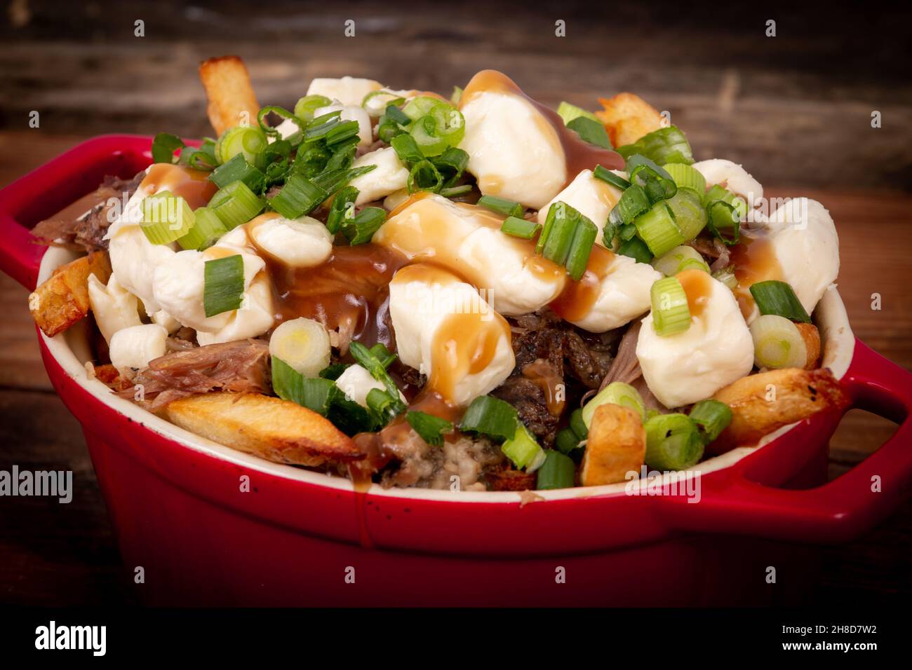 duck confit poutine dish on wood table poutine is a canadian meal made