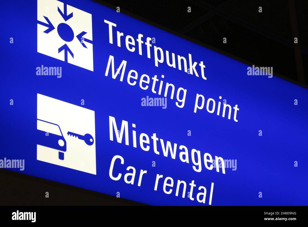 Generic airport info signage in Frankfurt Airport. Illuminated meeting