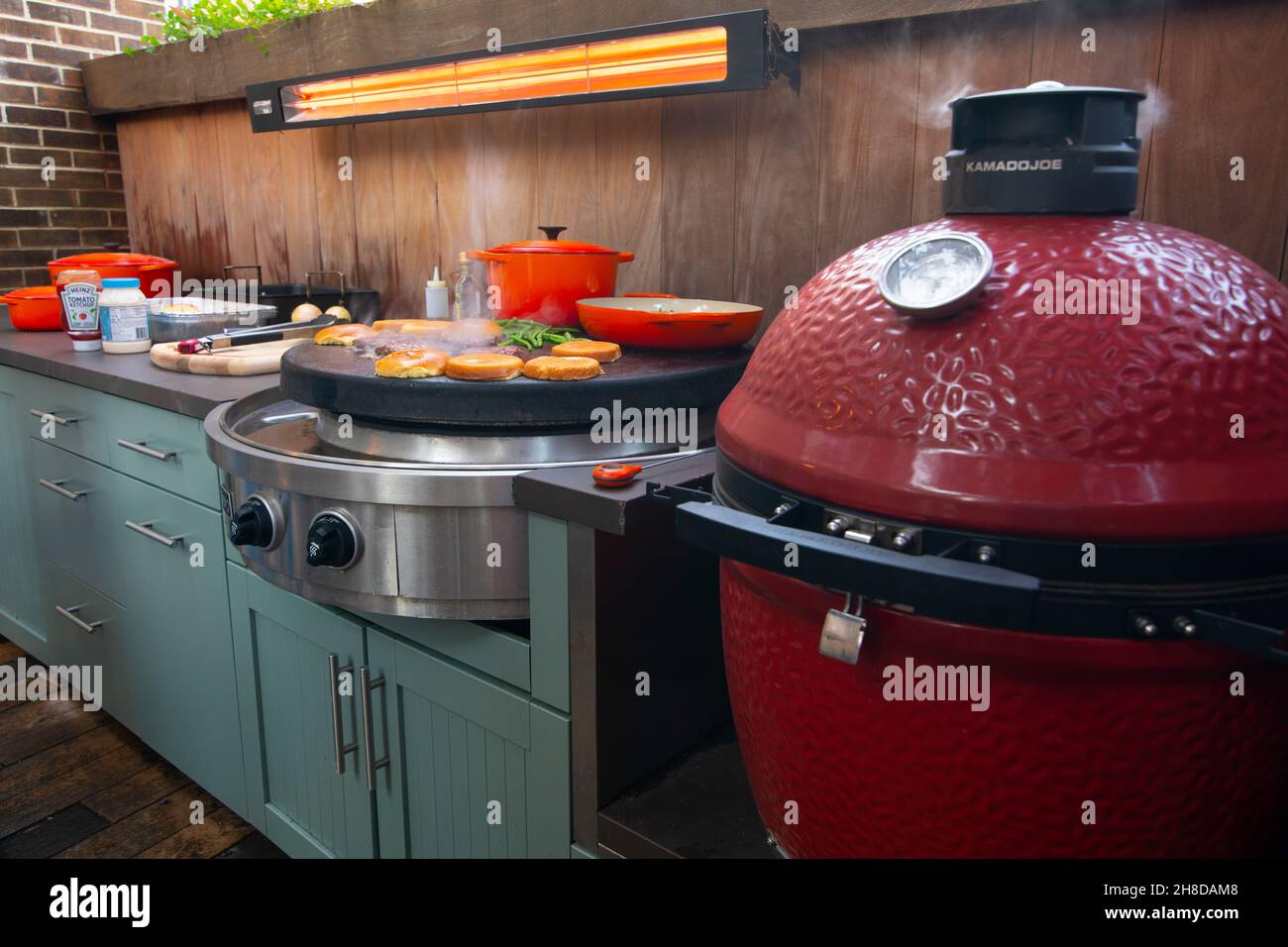 Outdoor kitchen smoker and flat top grill Stock Photo - Alamy