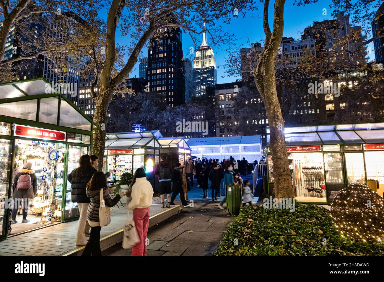 Bank of America Winter Village at Bryant Park with the Empire State Building looming in the background, New York City, USA Stock Photo