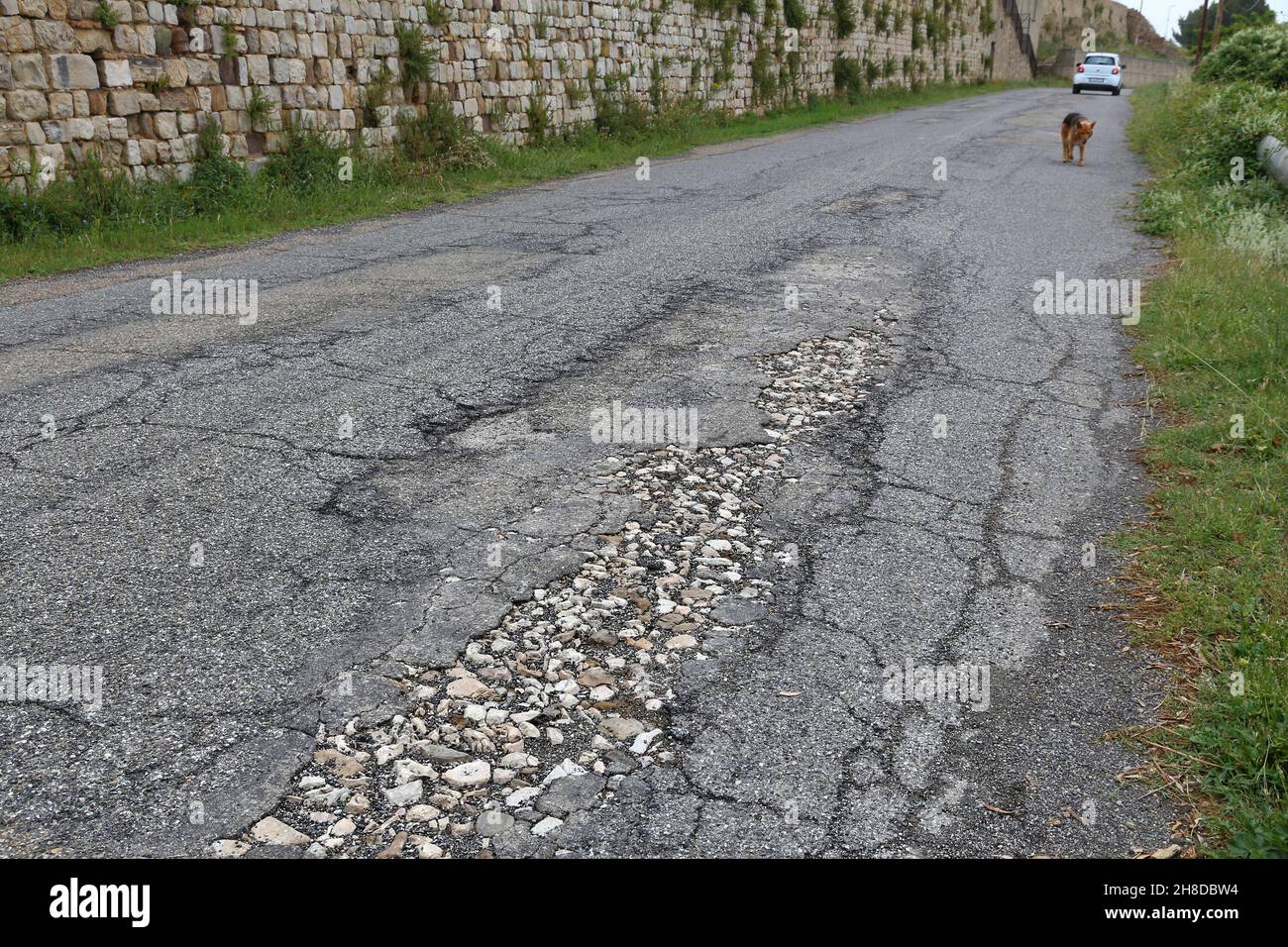 Road surface defects bad maintenance quality. Asphalt cracks in Italy Stock Photo Alamy