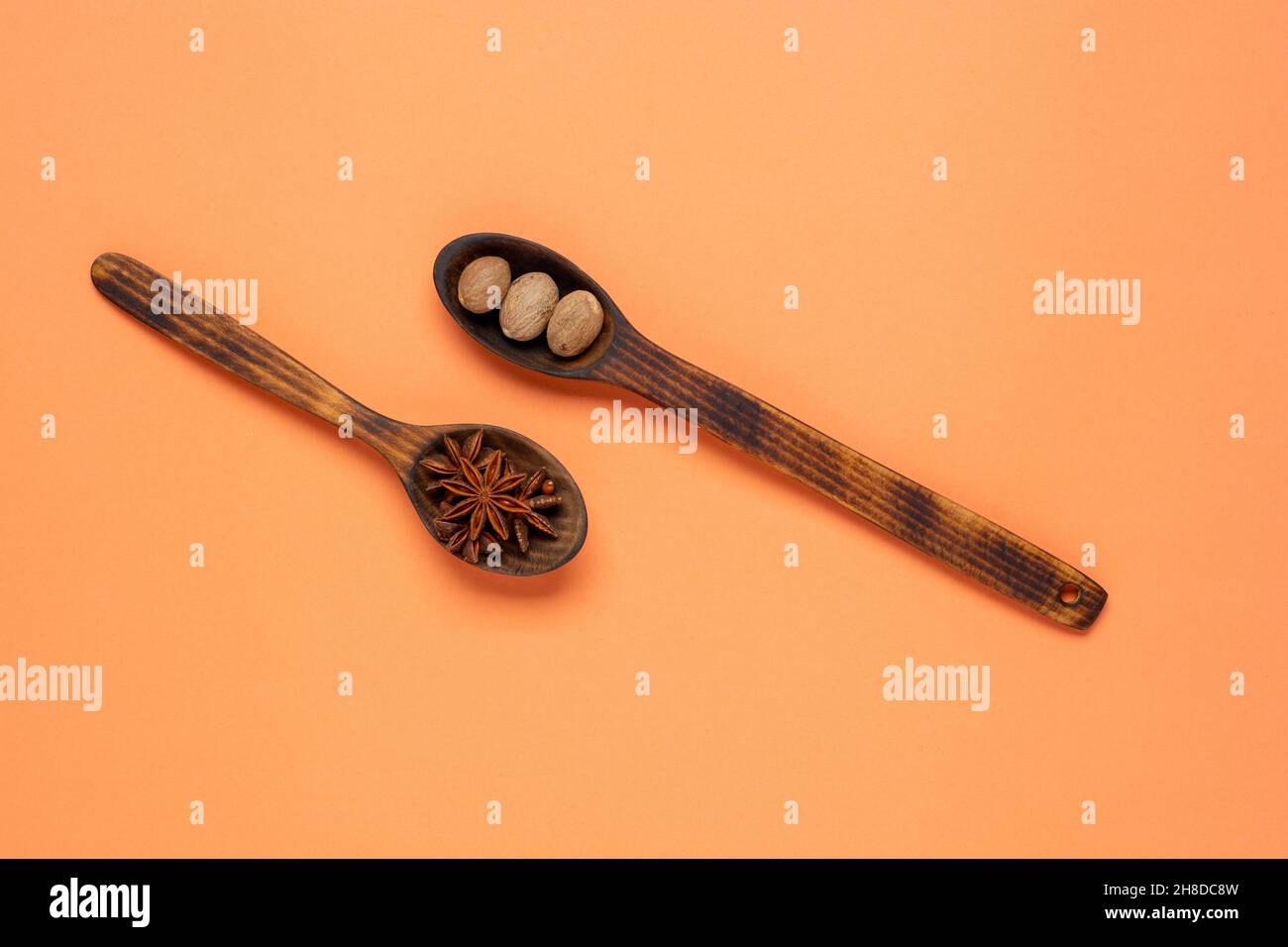 anise star and nutmeg in spoon on colorful background with copy space. Flat lay background. Stock Photo