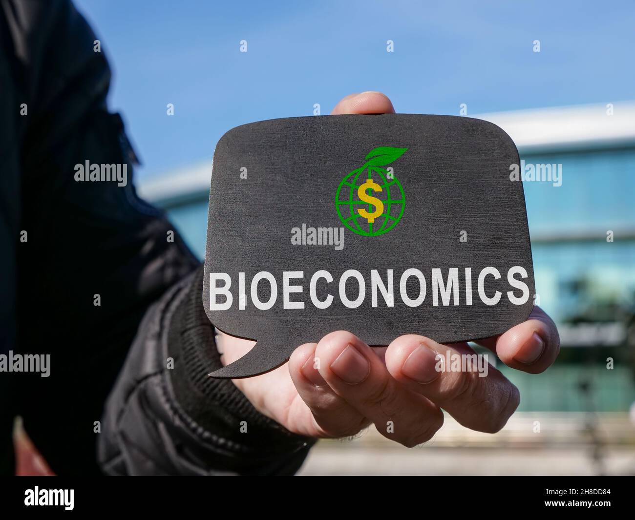 A man holds a tablet with word bioeconomy. Stock Photo