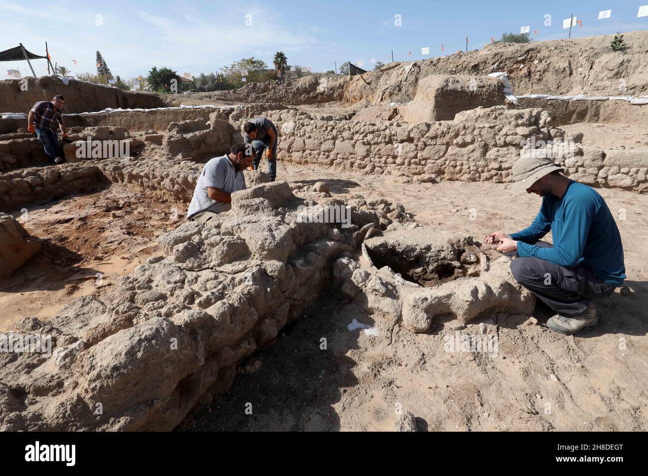 Yavne. 29th Nov, 2021. Staff members of Israel Antiquities Authority (IAA) work at an excavation site in central Israeli city of Yavne on Nov. 29, 2021. Israeli archaeologists have discovered remains of an industrial building and a nearby wide cemetery, both dating back to about 1,900 years ago, the Israel Antiquities Authority (IAA) said Monday. This is the first building discovered in the ancient central city of Yavne from the time of the Sanhedrin, which was the supreme legislative Jewish assembly. Credit: Gil Cohen Magen/Xinhua/Alamy Live News Stock Photo