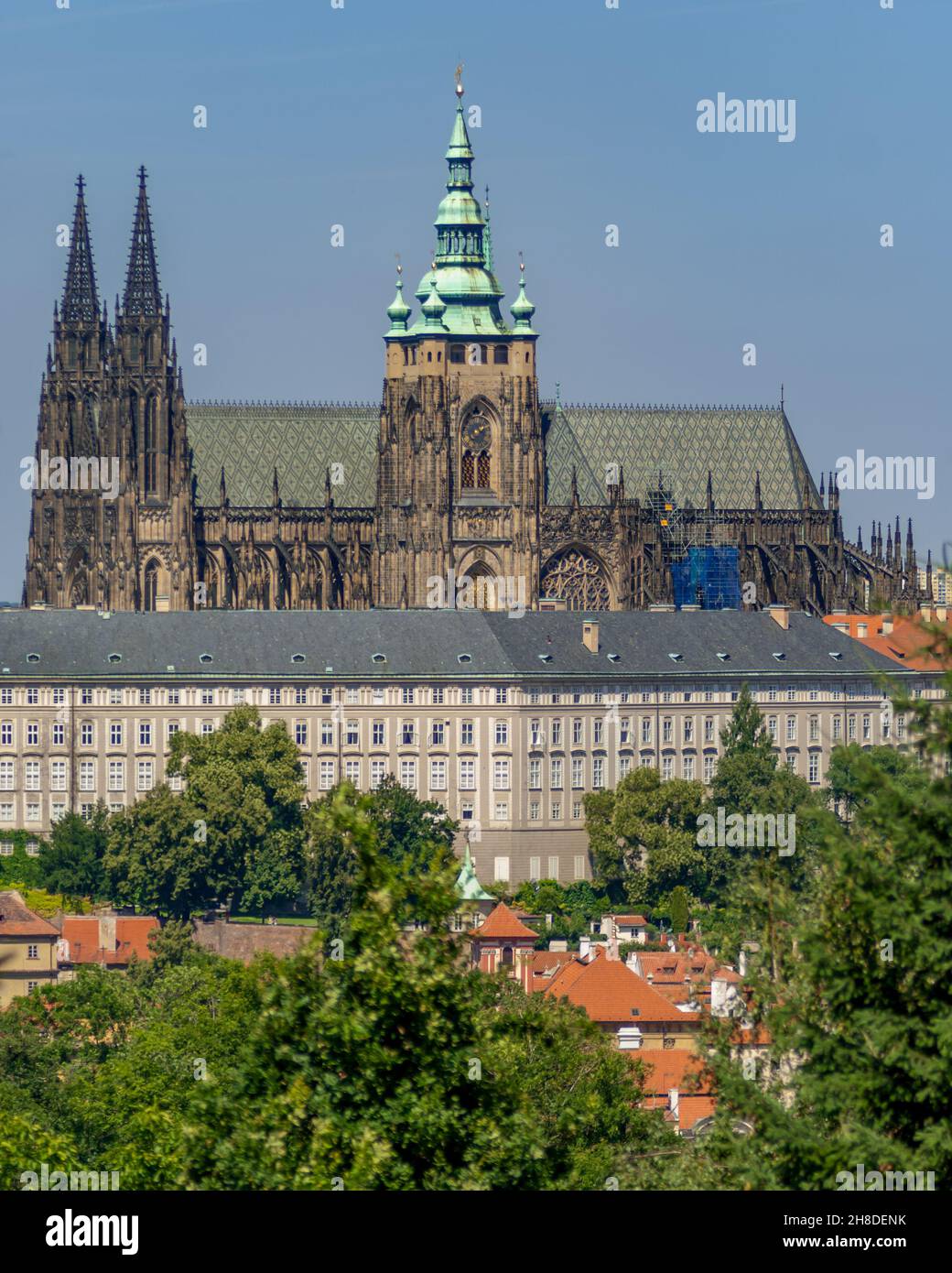 Prague Castle's St Vitus Cathedral rises over the New Royal Palace and the red-roofed buildings of the historic Malá Strana district. Stock Photo