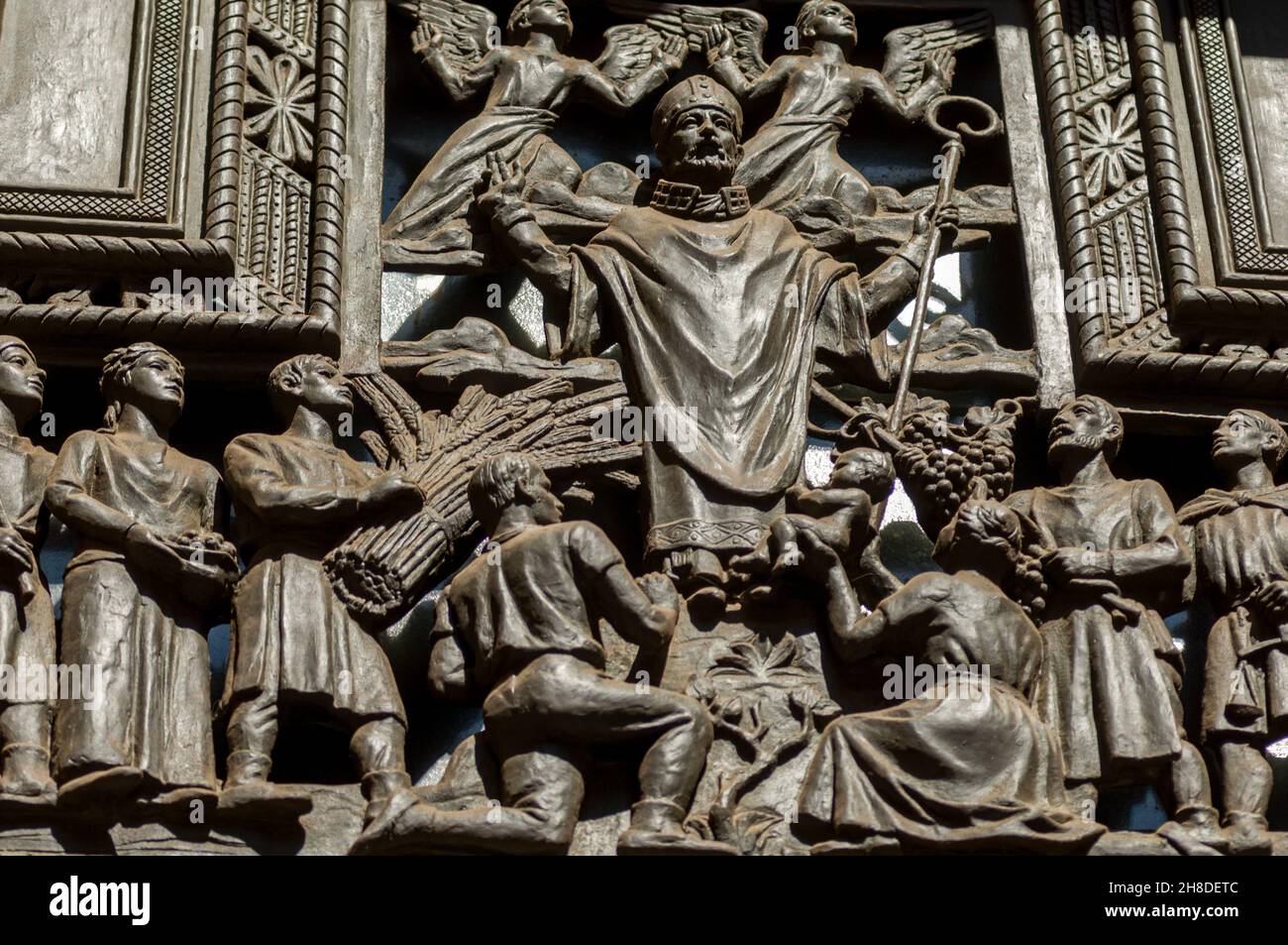 Detail of a bronze sculpture over a side door in the main facade of St Vitus Cathedral in Prague. Stock Photo