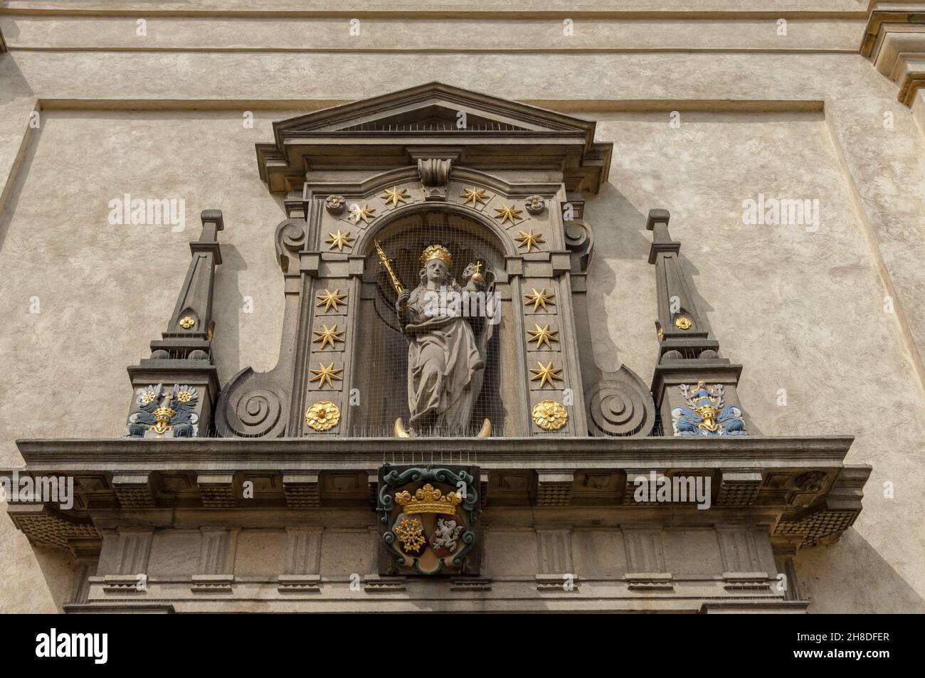 The ornate statue of 'Our Lady with the Child Jesus' above the entrance to the Church of Our Lady of Victories in Karmelitská Street in Malá Strana Stock Photo