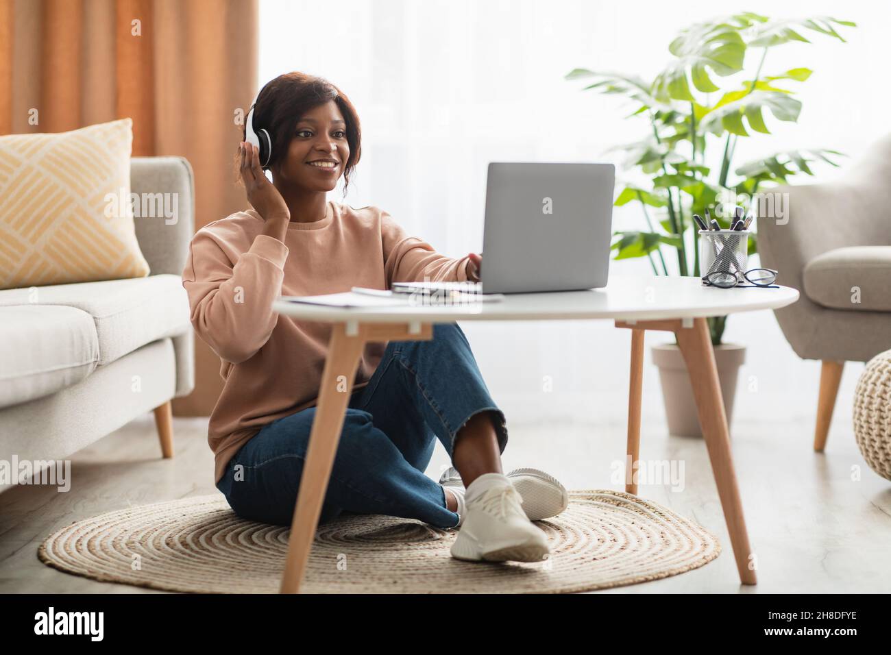 Black Freelancer Female Making Video Call Wearing Headphones At Home ...
