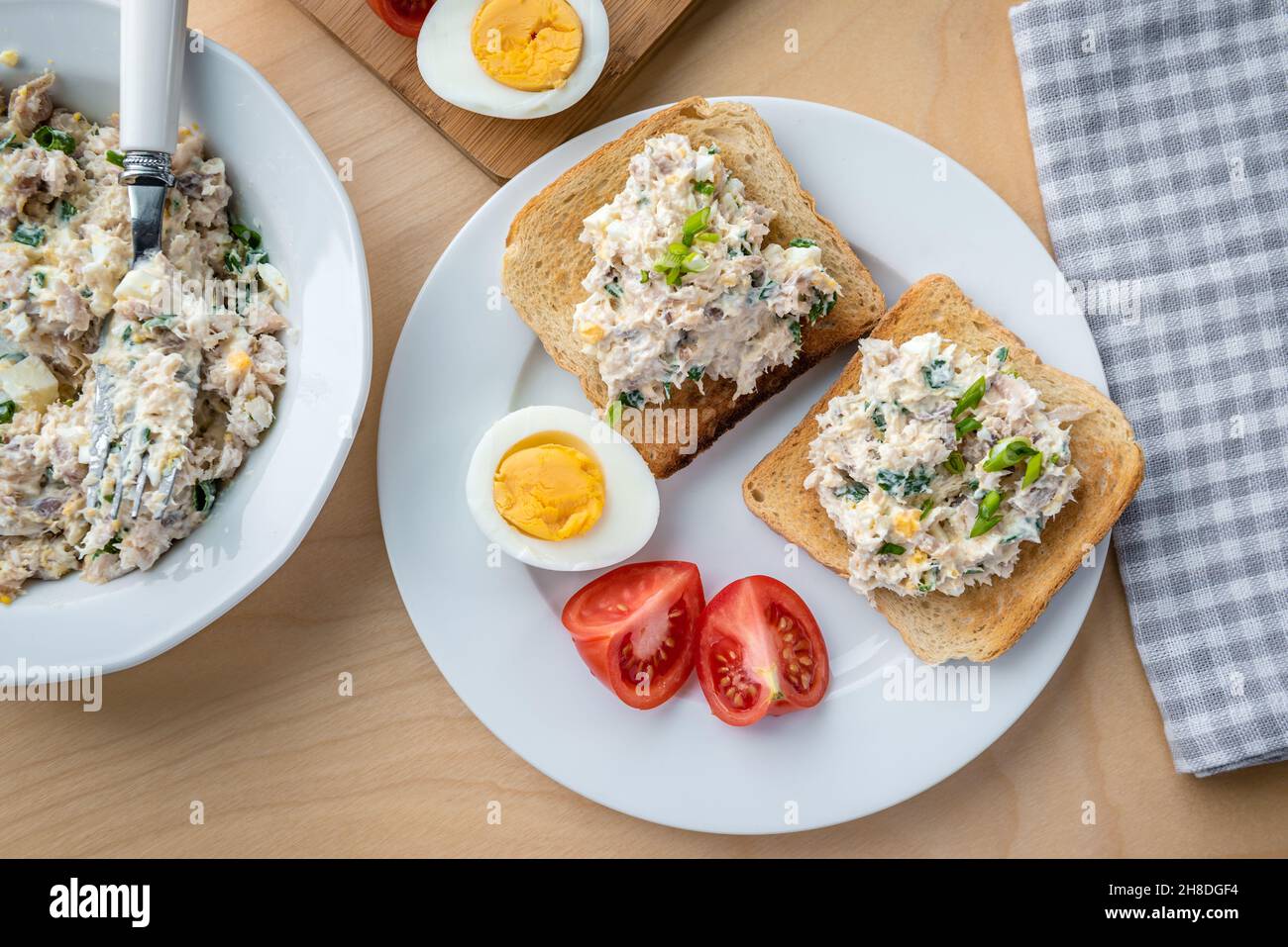 Toasts with smoked whitefish, egg, mayonnaise and chives Stock Photo