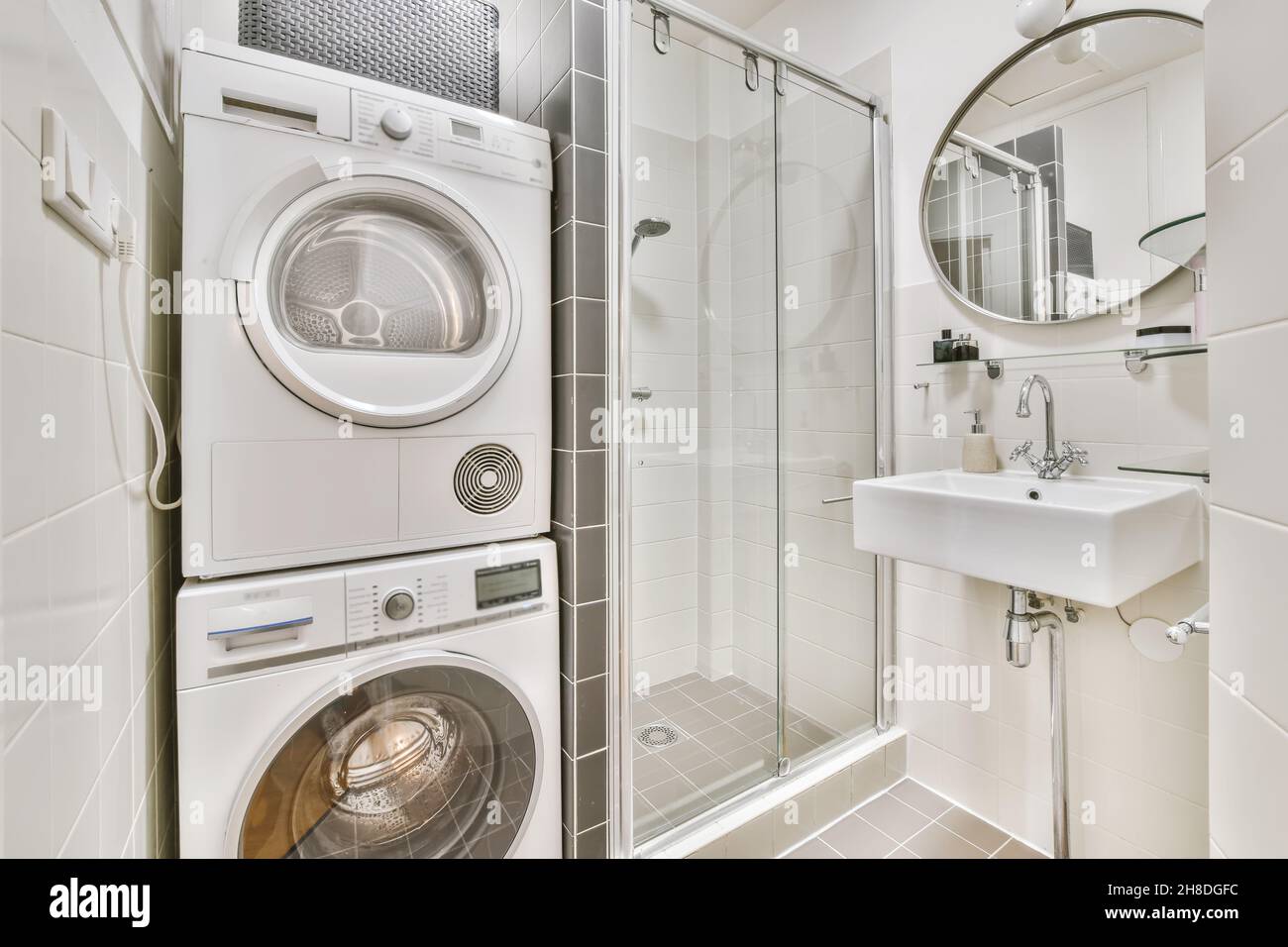 Bright bathroom with washing machine and dryer Stock Photo Alamy